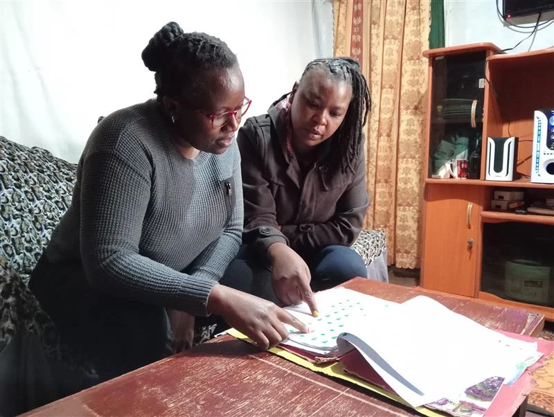 Elizabeth is a mother in Kenya seen here evaluating her poverty indicators. Credit: Nickson Ateku/Unbound
