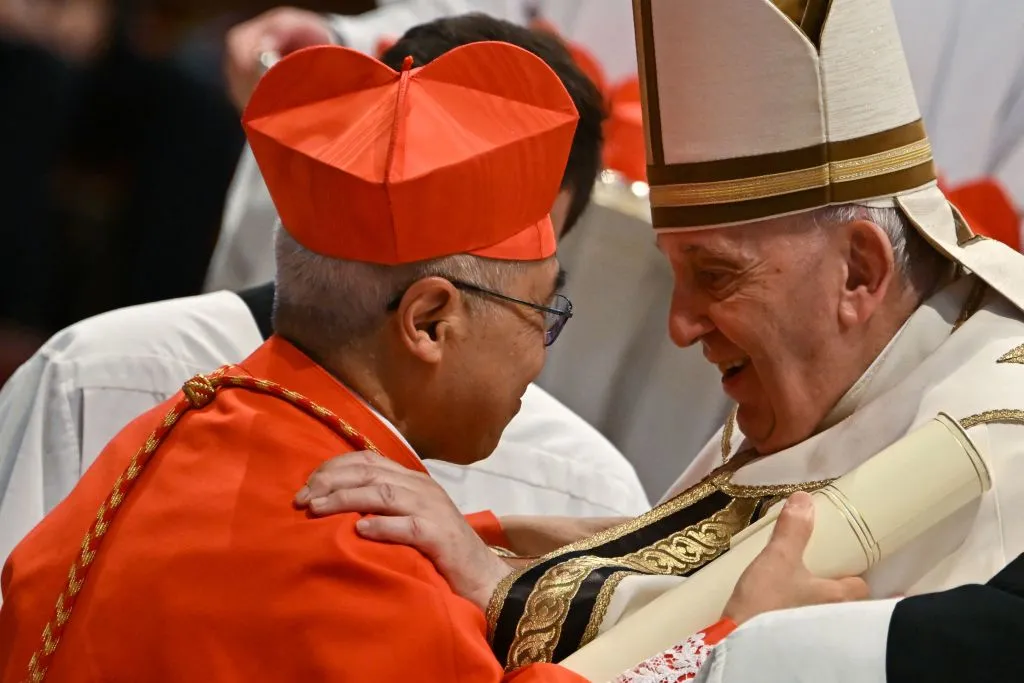 Pope Francis speaks to Archbishop William Seng Chye Goh (left) after he elevated him to cardinal during a consistory to create 20 new cardinals on Aug. 27, 2022, at St. Peter’s Basilica at the Vatican. Credit: Alberto Pizzoli