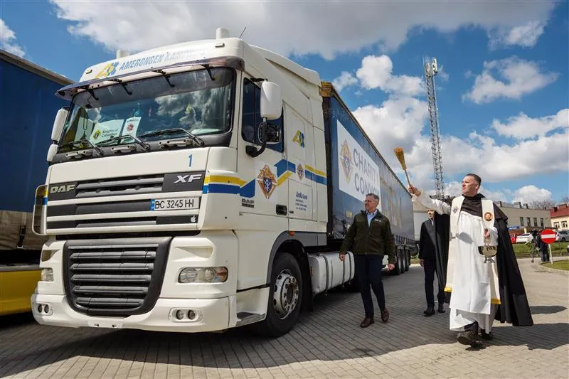 Father John Kalisch, director of chaplains and spiritual development at the Knights of Columbus, blesses a charity convoy in Lancut, Poland, in April 2022. Looking on is Supreme Knight Patrick E. Kelly, center. Photo credit: Photo by Tamino Petelinšek, courtesy of the Knights of Columbus