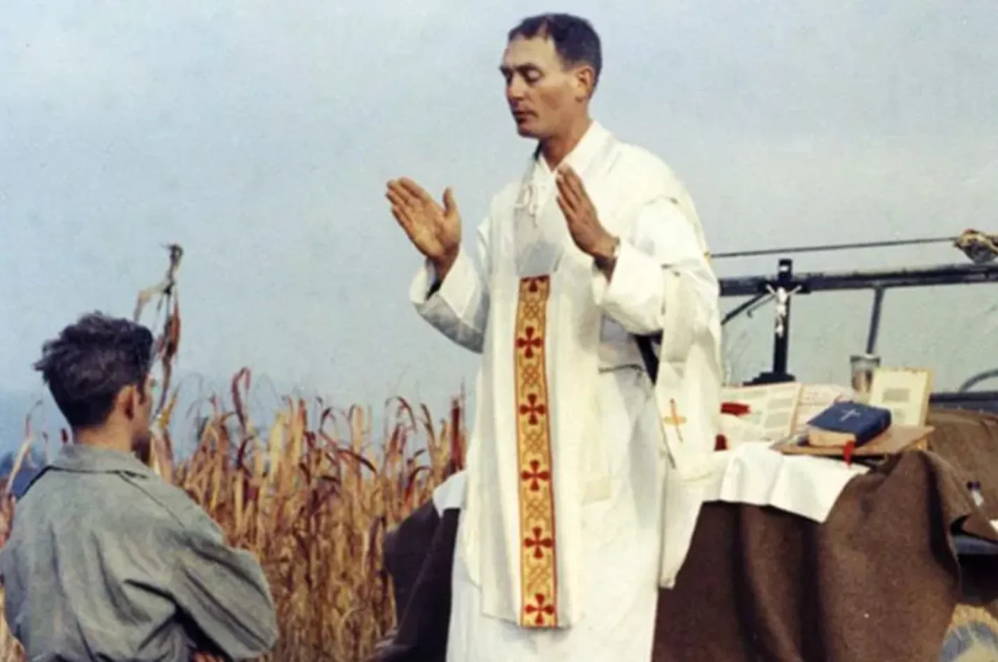 Father Emil Kapaun celebrates Mass using the hood of a Jeep as his altar on Oct. 7, 1950. Public Domain