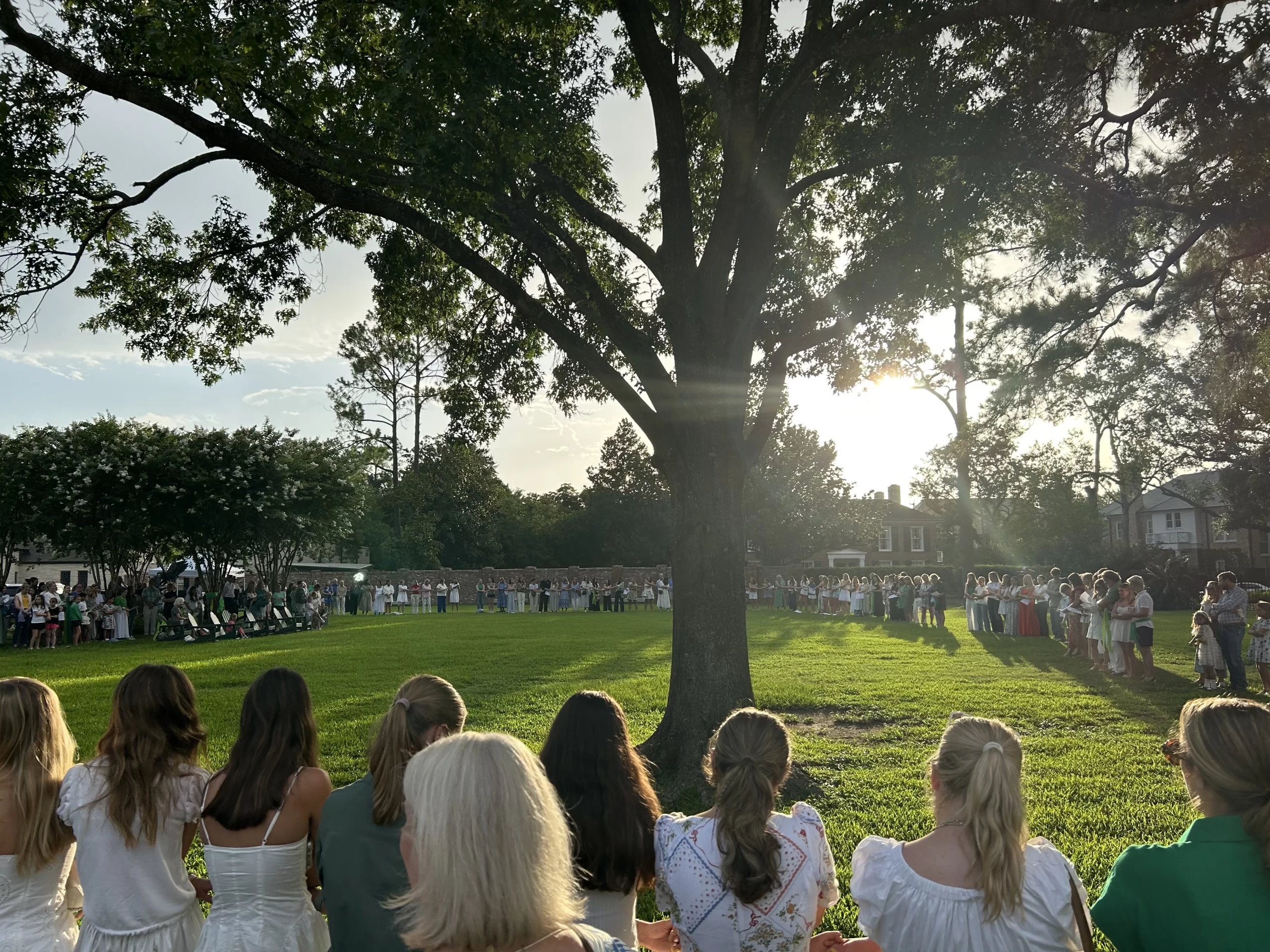 Camp Mystic alumnae and family sing after the memorial service on July 7, 2025, honoring victims of the flash floods in Central Texas last week. Credit: Amira Abuzeid/CNA