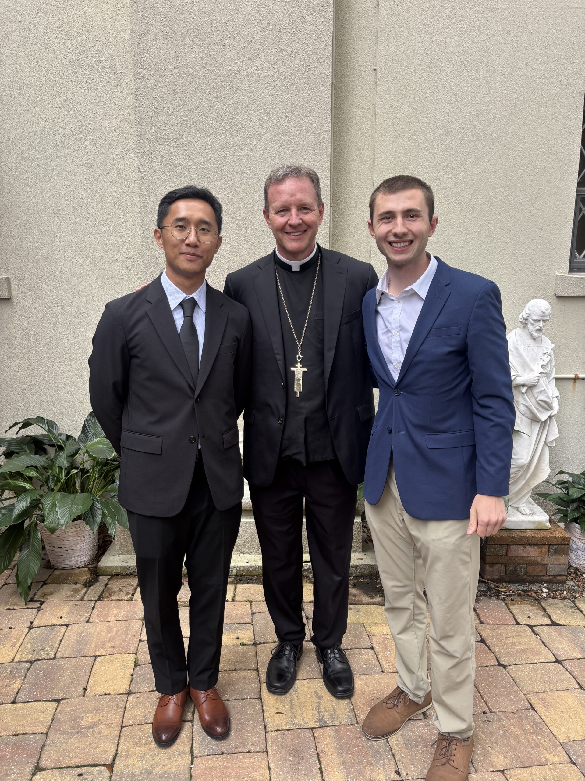 Tzu Ping Liu (Davis) and Robert Manoogian with Bishop Erik T. Pohlmeier of the Diocese of St. Augustine, Florida, after the Rite of Election, which took place on Feb. 28, 2026, at the Cathedral Basilica of St. Augustine. | Credit: Photo courtesy of Robert Manoogian