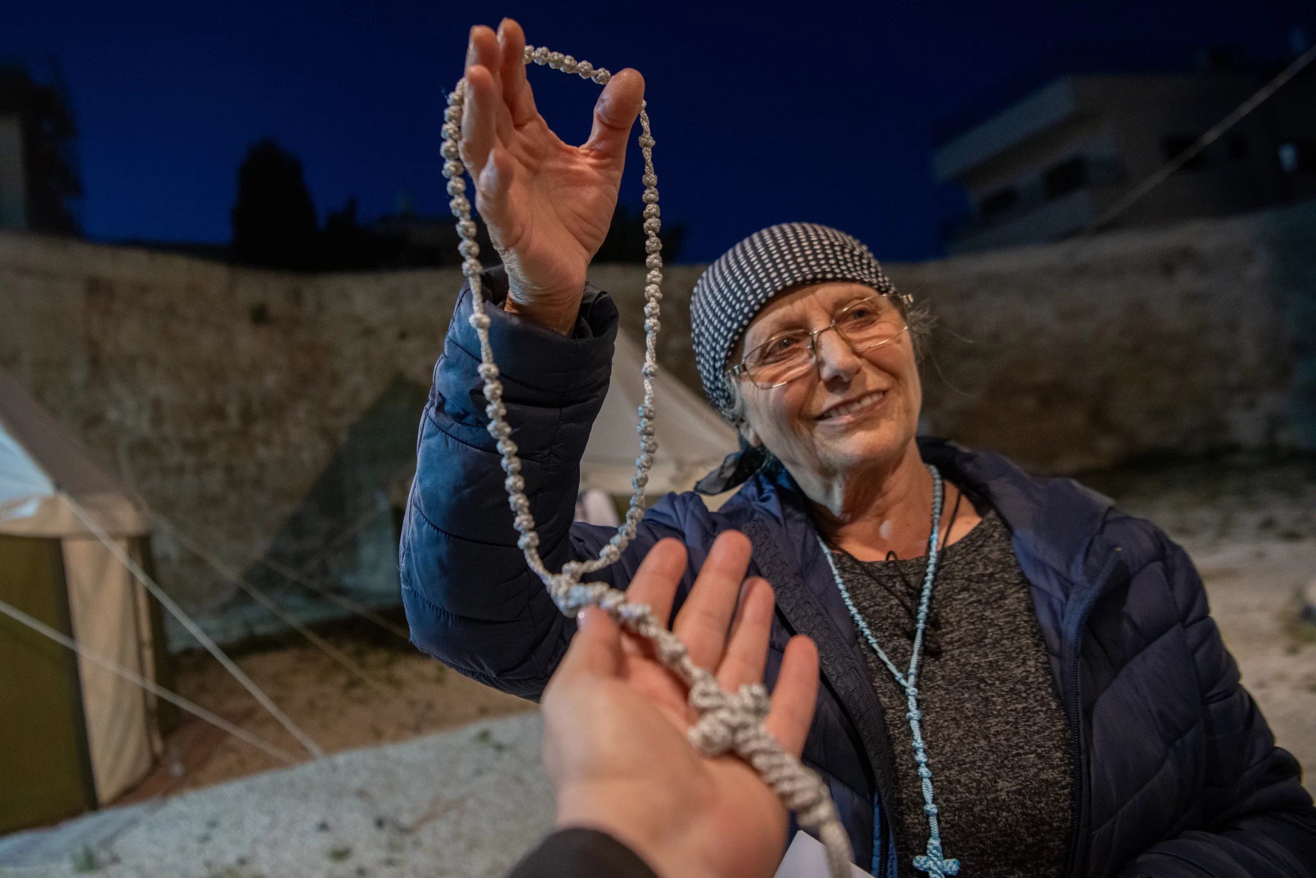 Emily Turjman, a well-known figure in the Latin parish of Jerusalem, outside the Chapel of the Ascension on the Mount of Olives in Jerusalem. She's showing the rosaries she crafts with embroidery, before the vespers of the Ascension solemnity on May 8, 2024, organized by the parish. “I come here every year,” she told CNA. “I love the Lord and want to be close to him,” she said. Credit: Marinella Bandini