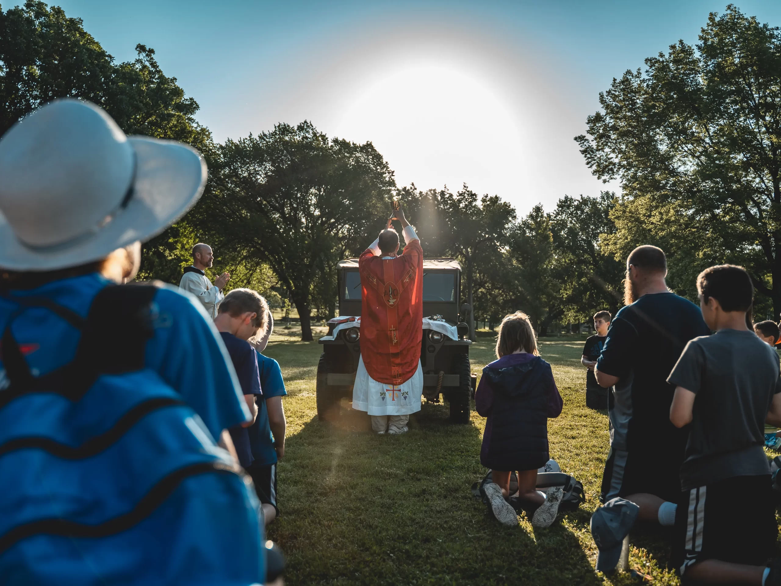 Pilgrims celebrate Mass on the hood of a Jeep during the Kansas Camino, emulating a famous photo of Father Emil Kapaun. Credit: Diocese of Wichita