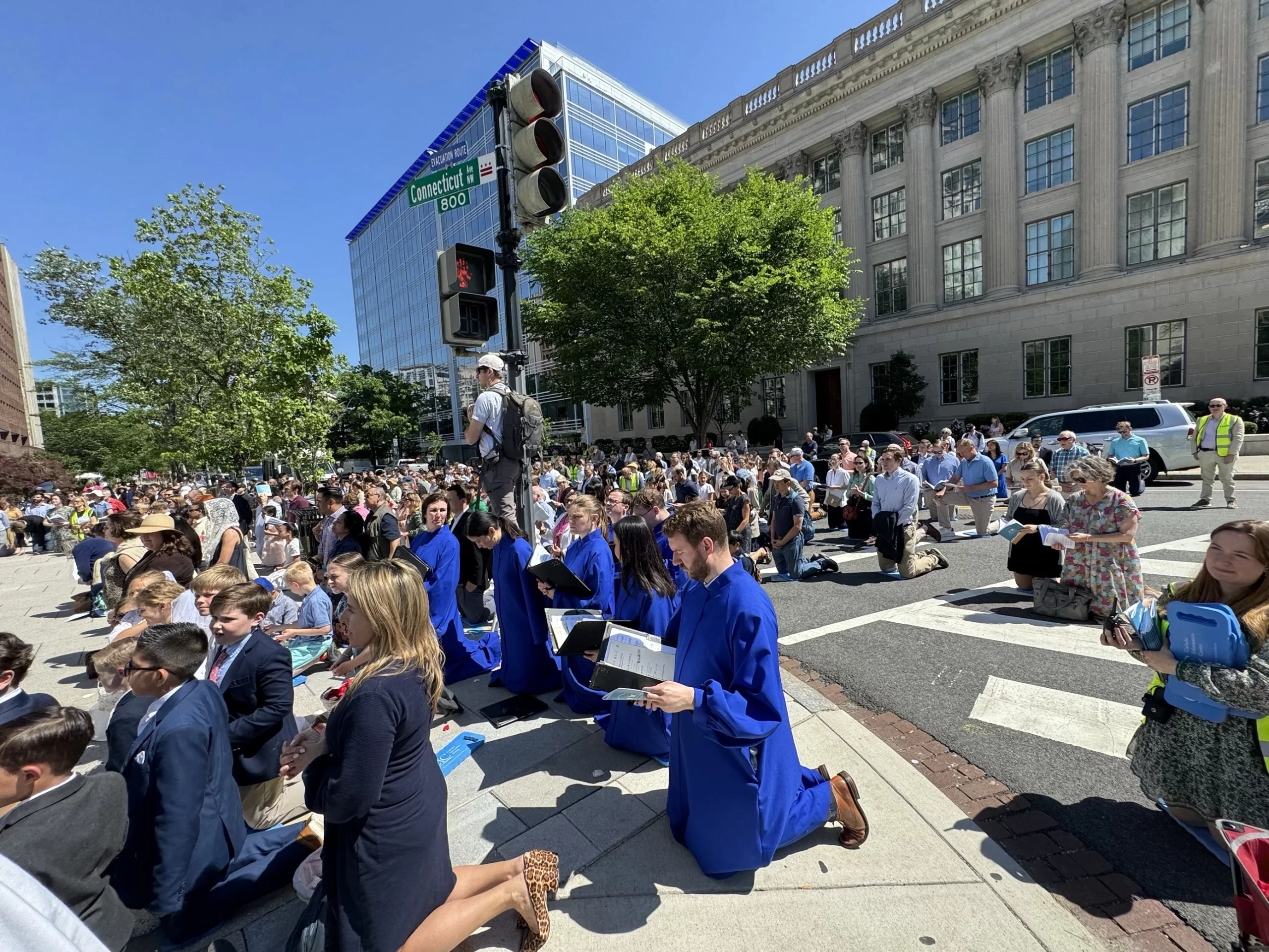 The faithful kneel during a Eucharistic procession through Washington, D.C., Saturday, May 17, 2025. Credit: Tessa Gervasini