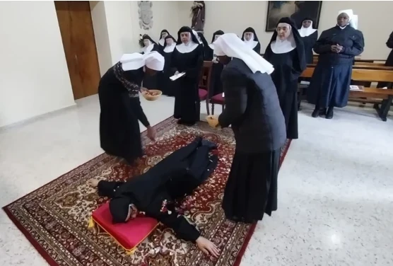 Sister Maria Zhang prostrates herself on the floor as a sign of humility during the rite for making her perpetual vows. Credit: Diocese of Salamanca