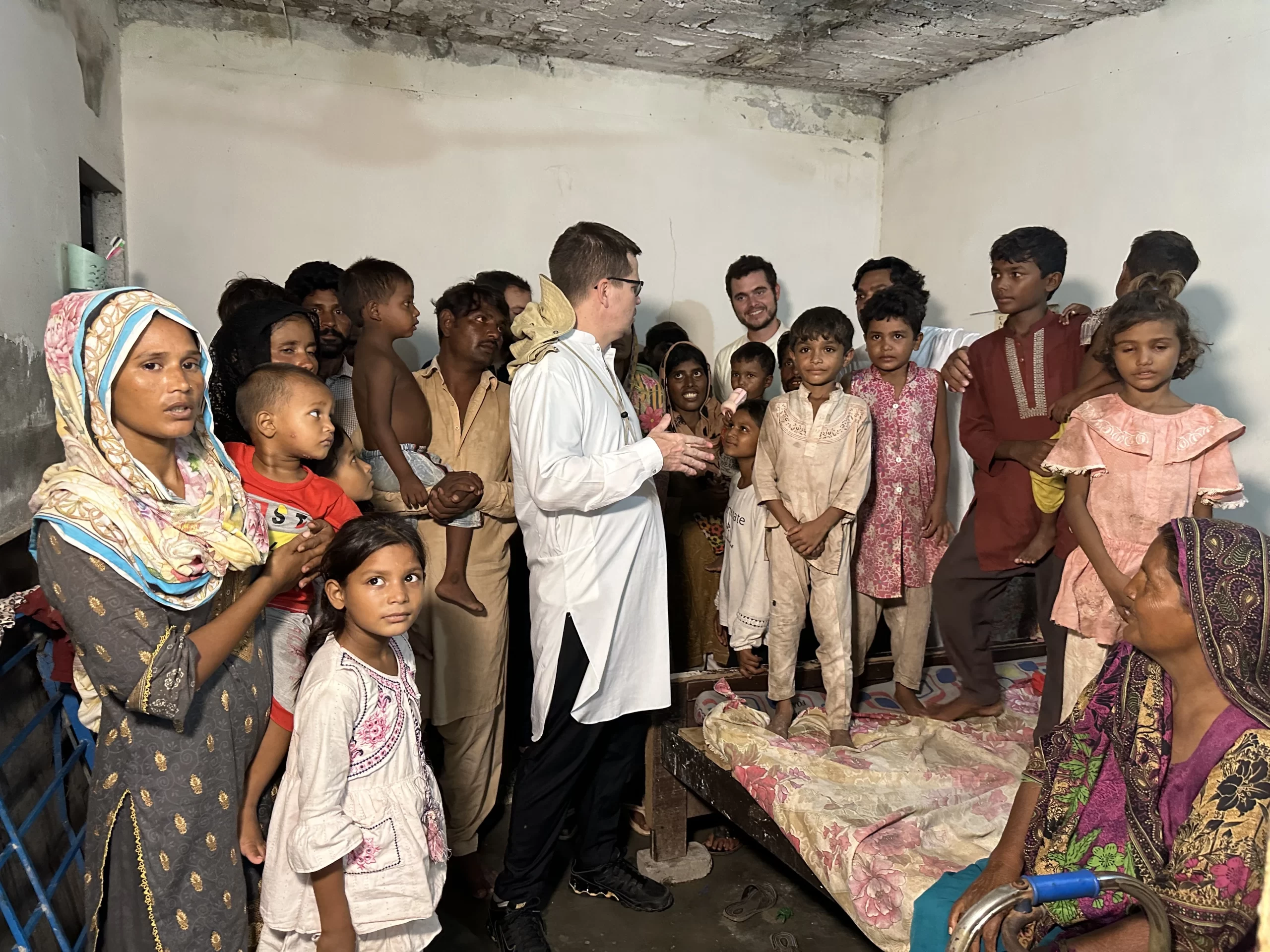 Father Rico is pictured with Christian children and family members in Pakistan whom he has ransomed from debt bondage. According to the U.N., between 3.5 million and 5 million people  are engaged in bonded or forced labor in which whole families are compelled to work. Credit: Photo courtesy of the Order of St. Elias