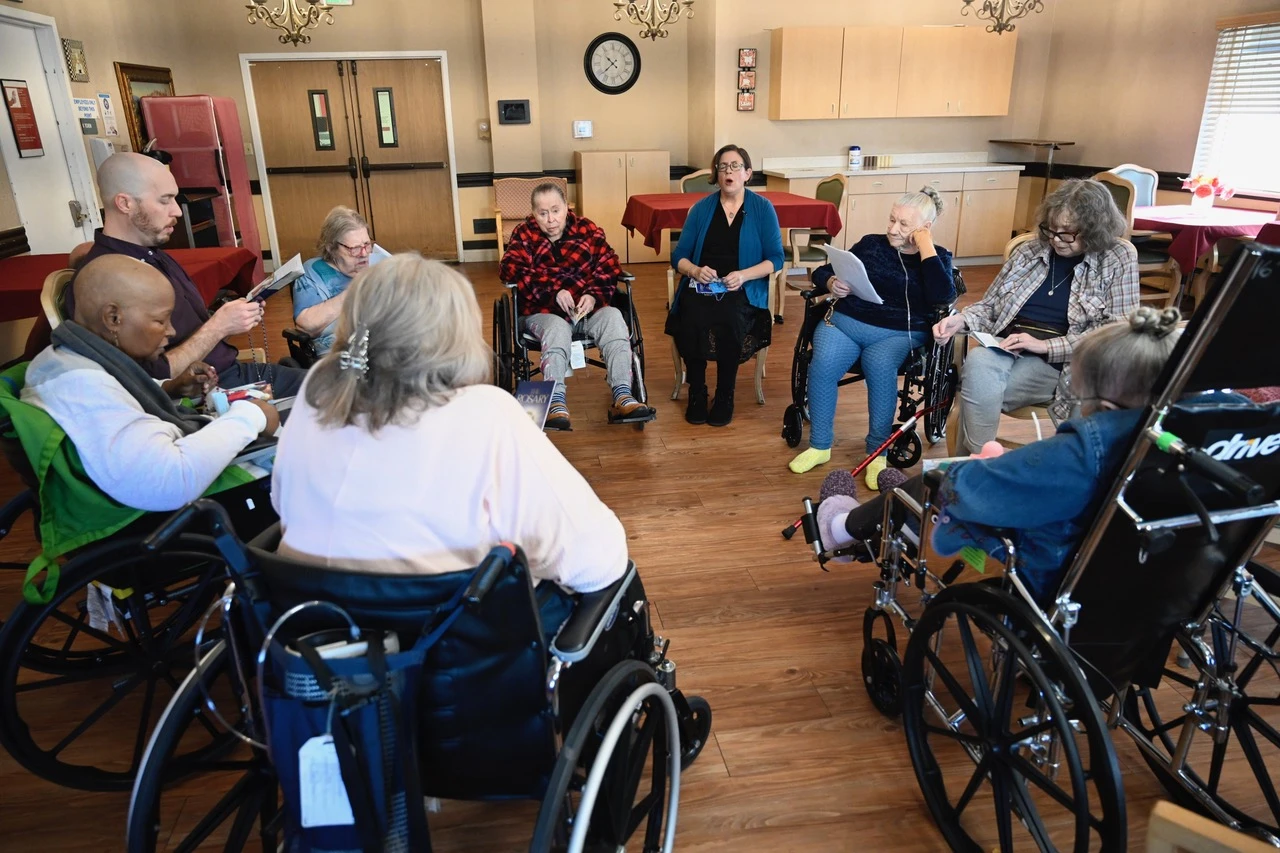 Rosary Team volunteers pray with residents at a memory care facility. Credit: The Rosary Team