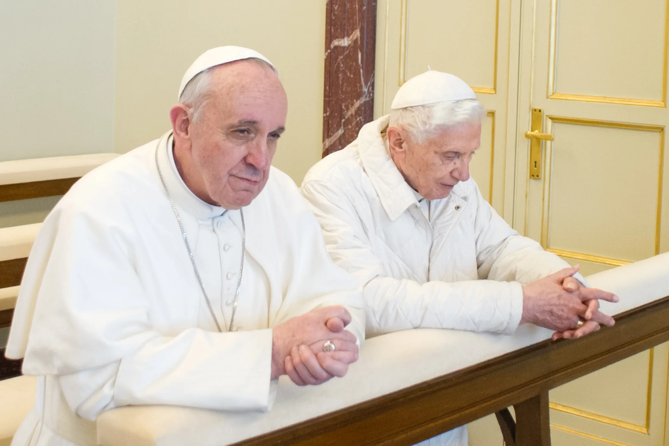 Pope Francis and Pope Emeritus Benedict XVI pray together at the papal residence in Castel Gandolfo March 23, 2013, their first meeting after Francis' election. Vatican Media