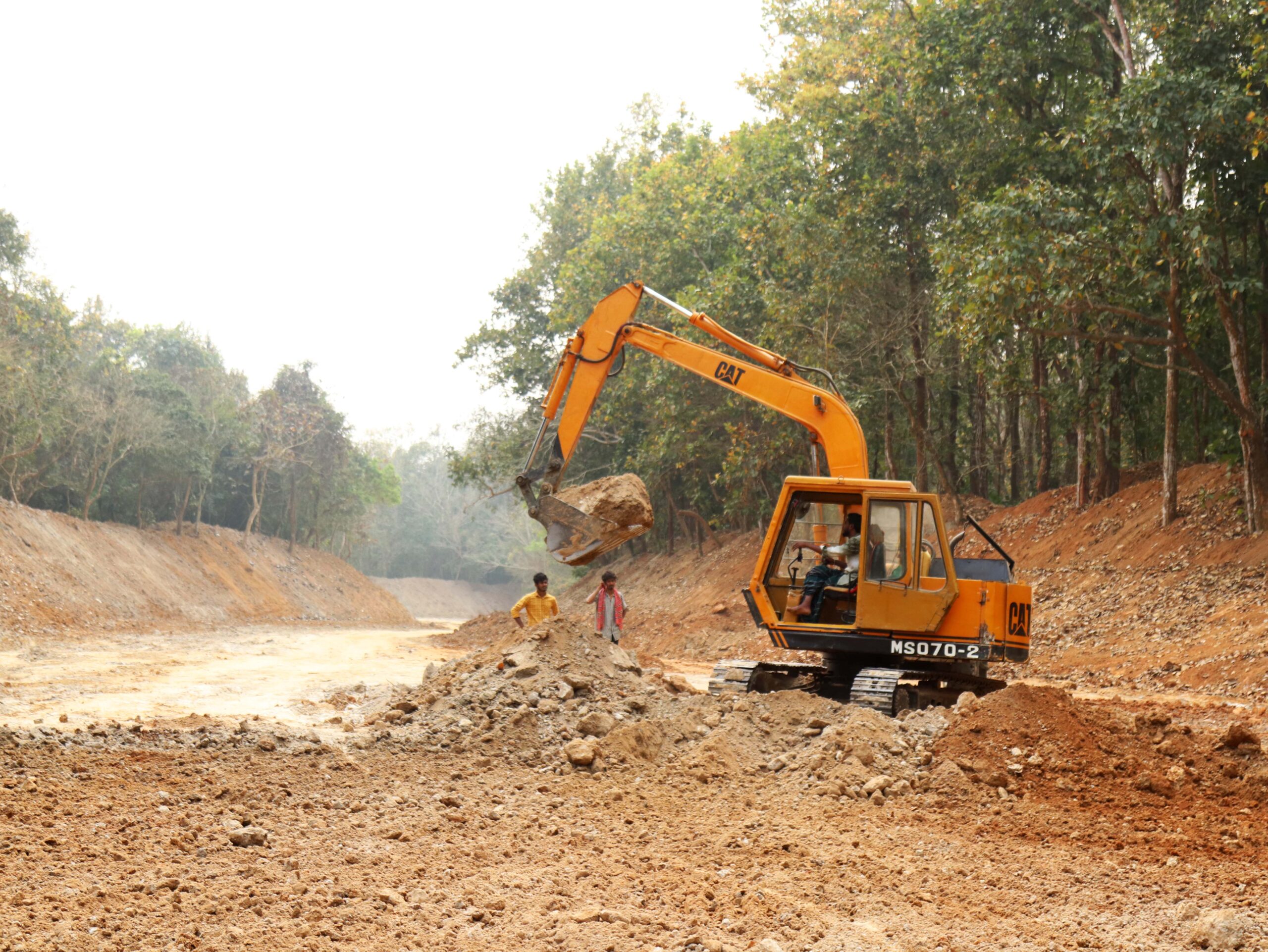 An excavator digs inside the Madhupur forest in Bangladesh on March 6, 2026, as part of a government project to expand an artificial lake that Indigenous communities say threatens their ancestral land. | Credit: Stephan Uttom Rozario