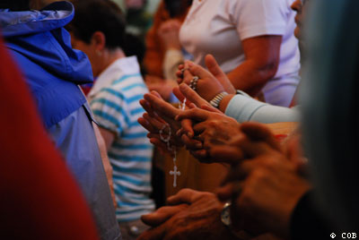 People Praying The Rosary