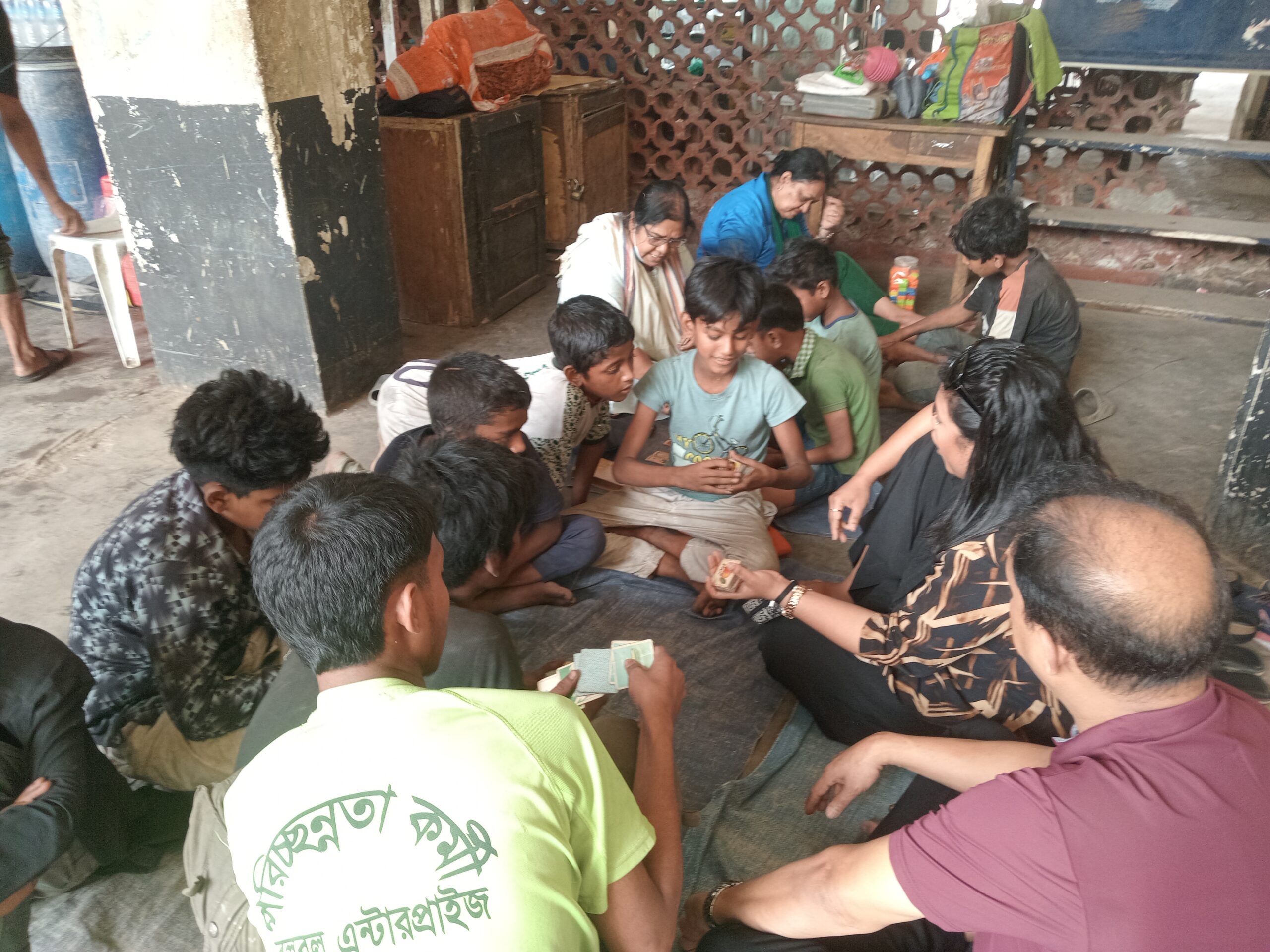 Catholic volunteers sit with street children during an activity session in Dhaka, Bangladesh, on March 14, 2026. | Credit: Sumon Corraya
