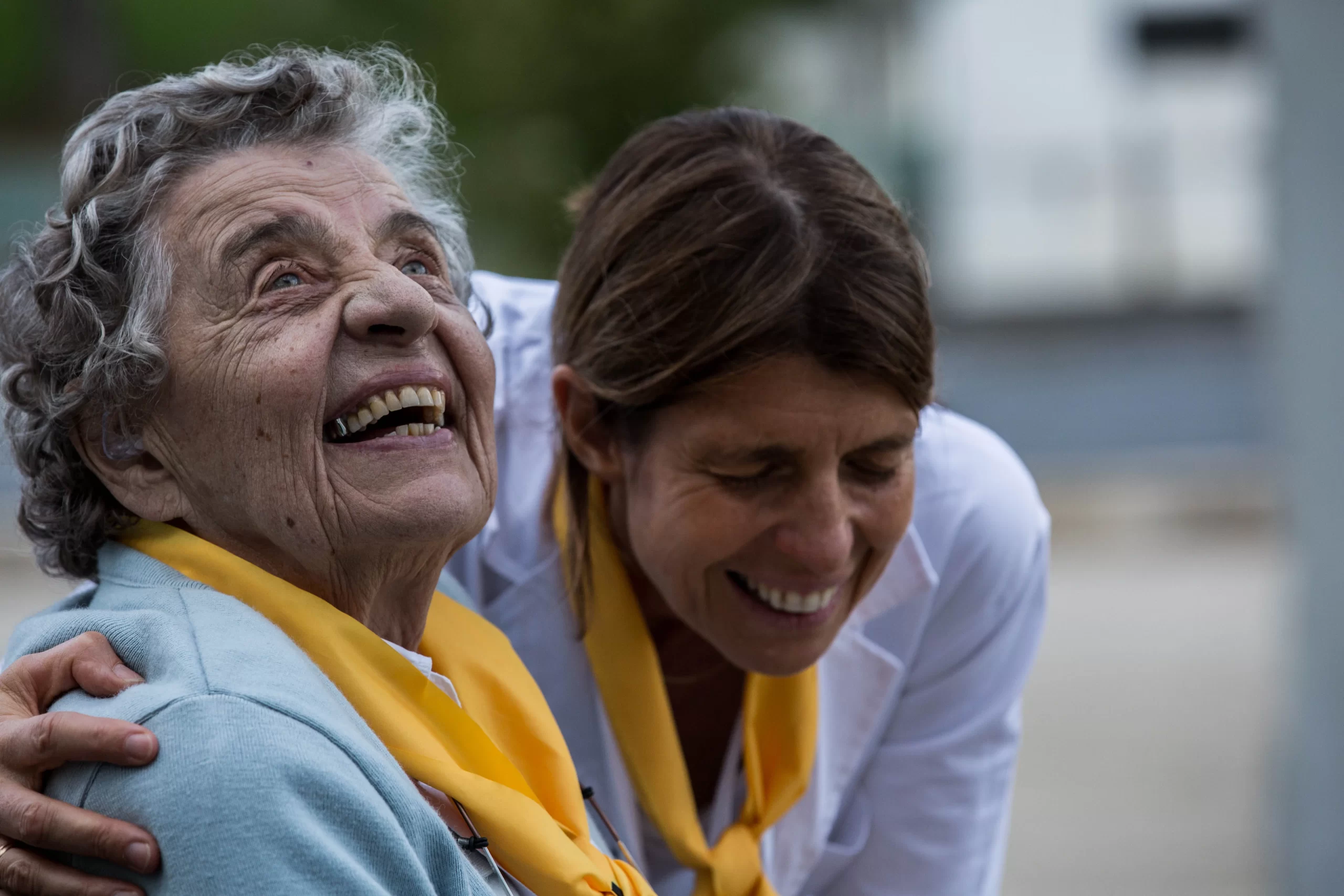 A volunteer at Lourdes pilgrims sharing a laugh with a pilgrim. Bosco Films