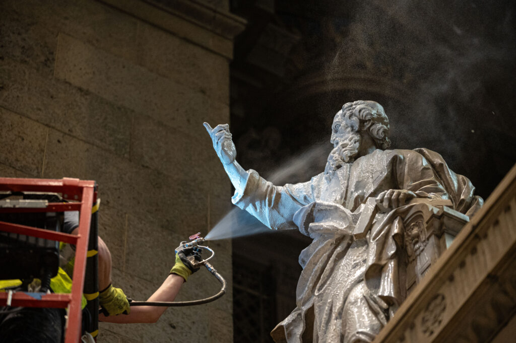 A specialty cleaning material is sprayed on a statue of St. Peter at the Basilica of Saint Mary in Minneapolis in an undated photo. | Credit: Ken Fournelle/Courtesy of the Basilica of Saint Mary