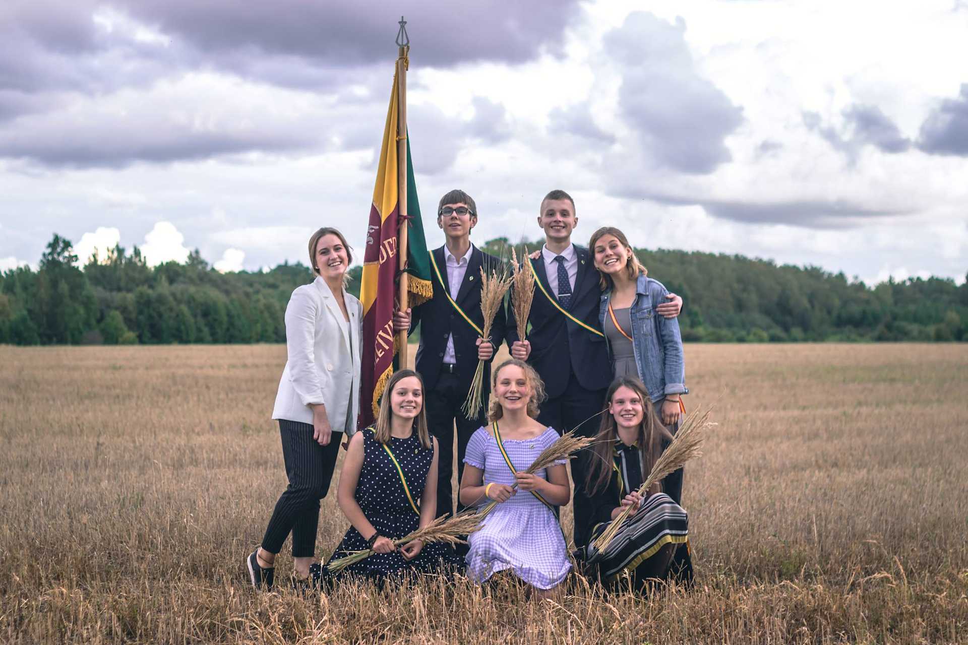 Members of the Ateitis Federation pose with the organization’s flag in the Lithuanian countryside. | Credit: The Ateitis Federation 