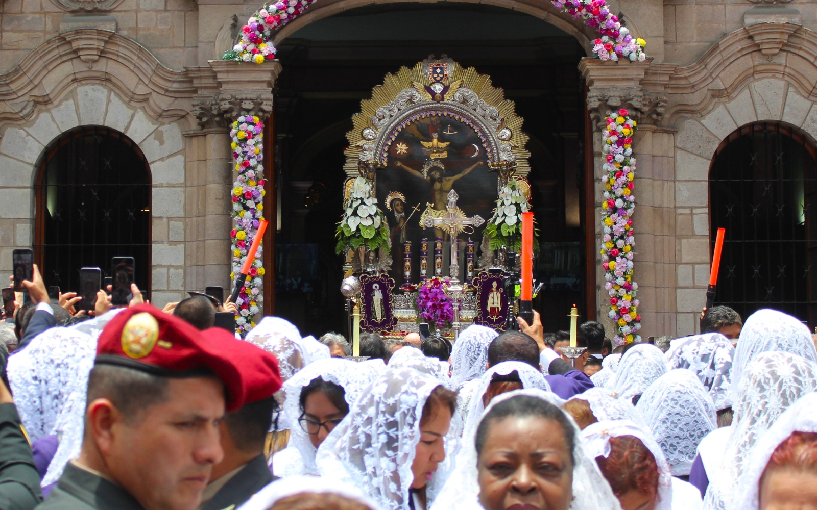 Thousands of people come to venerate the Lord of Miracles during a procession in downtown Lima, Peru. | Credit: DJSully/Shutterstock