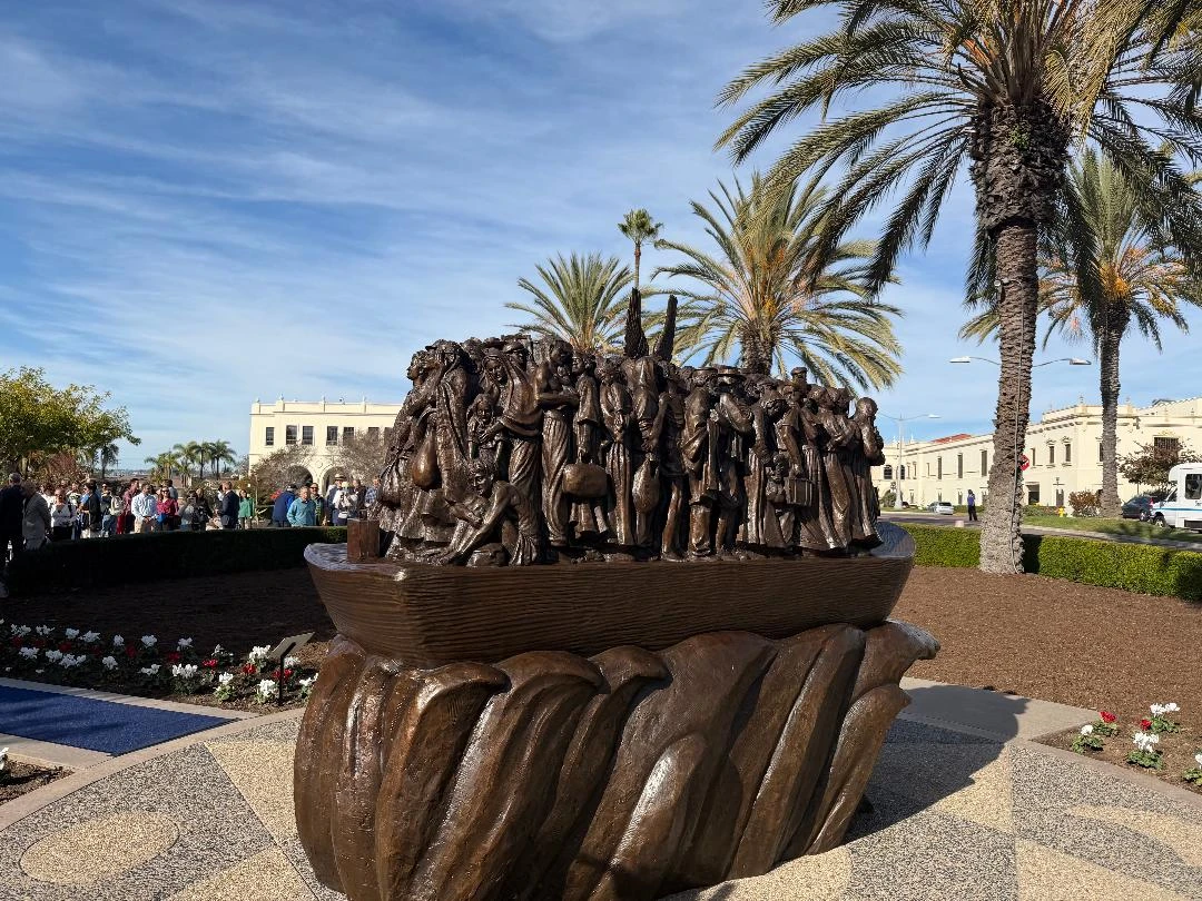 "Angels Unawares," a new sculpture on the campus of the University of San Diego (USD), was installed on Thursday, Dec. 18, 2025.  The 8-foot-tall bronze sculpture is a scaled version of one in St. Peter’s Square in Rome that was commissioned by Pope Francis in 2019 and depicts 140 migrants of varying backgrounds on board a boat with a pair of angel wings in their midst. Credit: University of San Diego
