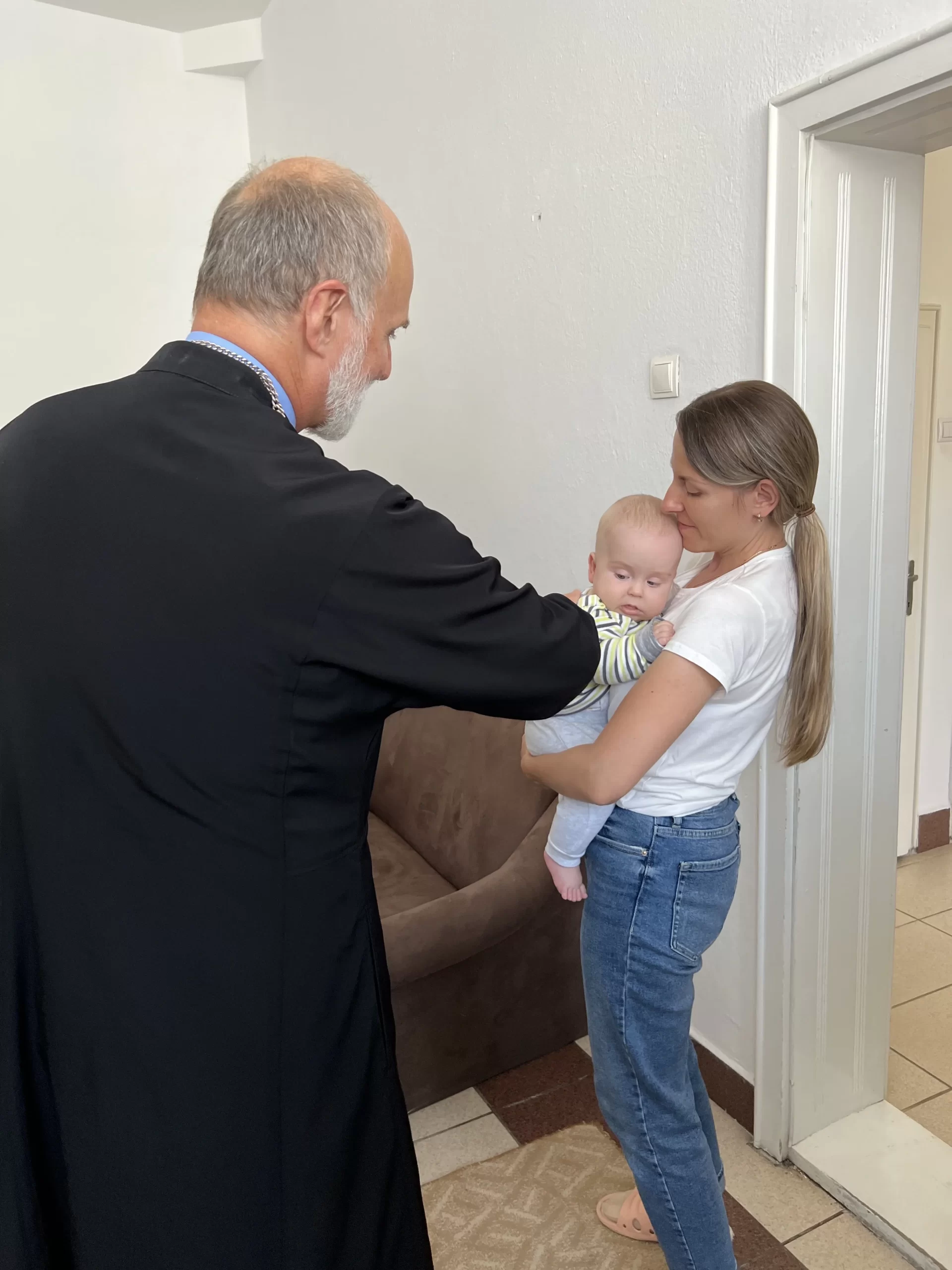 Archbishop Borys Gudziak meets with a Ukrainian refugee family in Romania. Photo courtesy of Ukrainian Catholic Archeparchy of Philadelphia