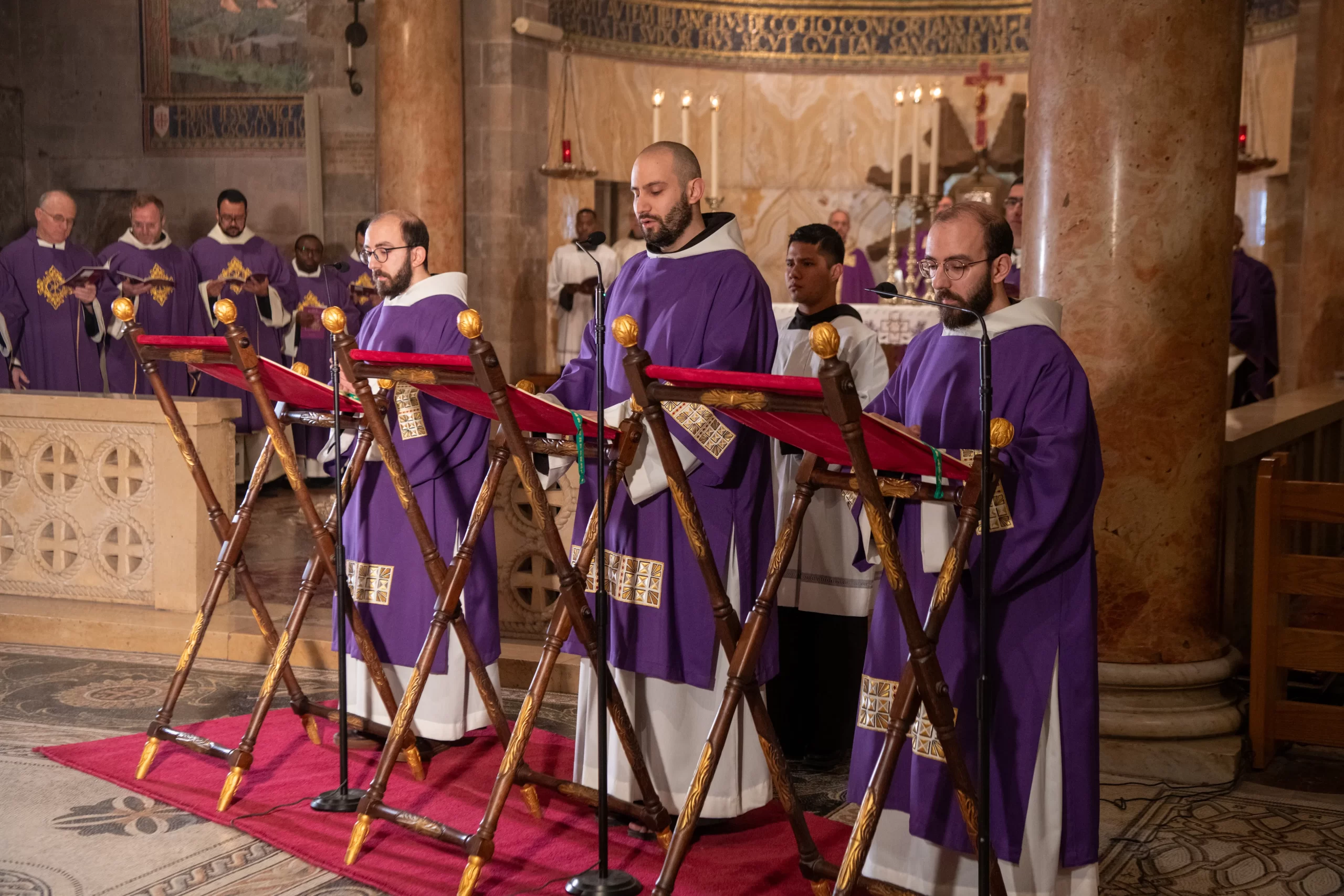 Three friars of the Custody of the Holy Land chant the Passion according to Luke (Lk 22:14-23:56) during the Holy Wednesday Mass on March 27, 2024. In Jerusalem on Holy Wednesday, the friars of the Custody of the Holy Land venerate the two stones that, according to the Gospel of Luke, were stained with the blood of Jesus during his Passion. Credit: Courtesy of the Custody of the Holy Land