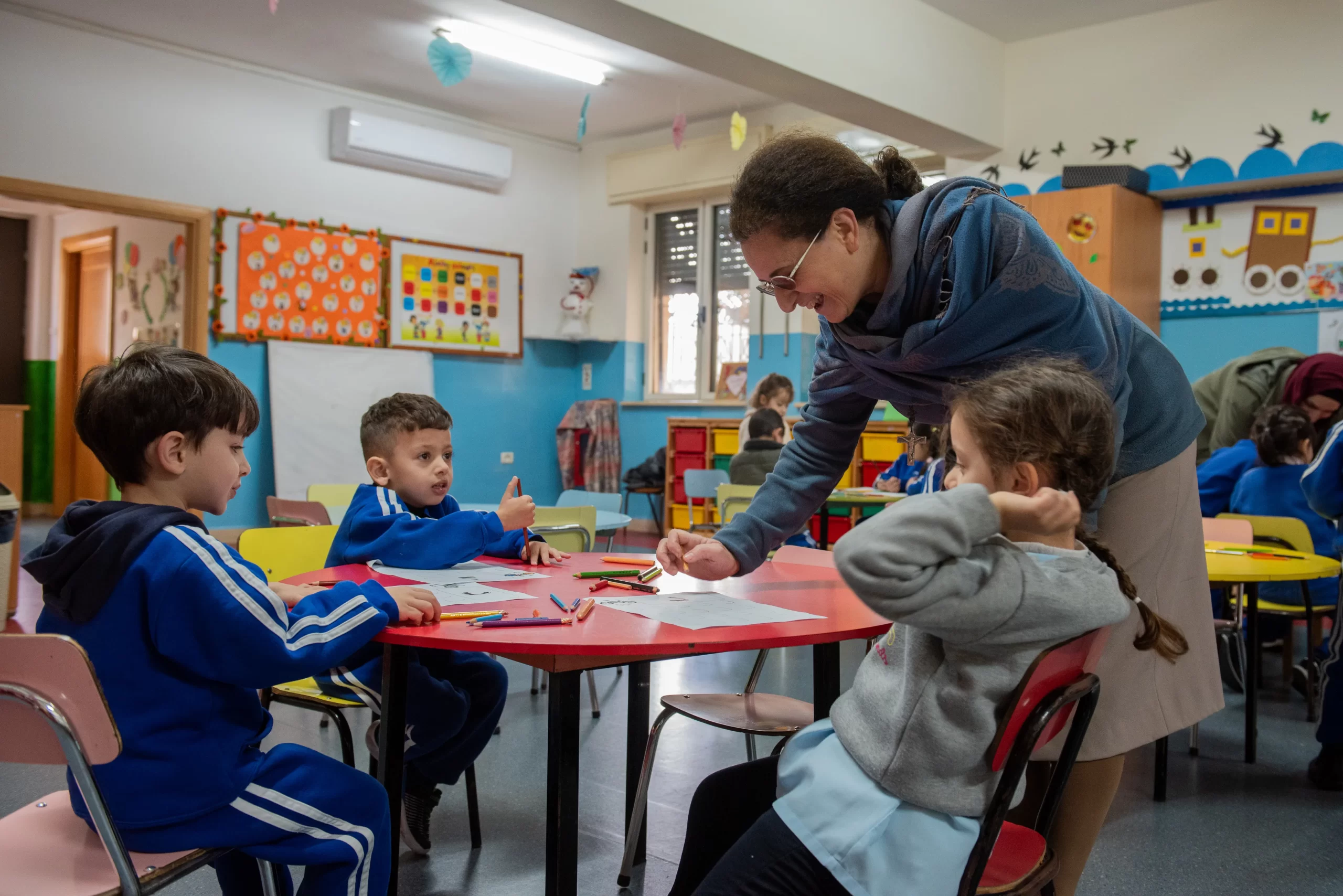 Sister Anna Maria Sgaramella of the Comboni Sisters talks with the children in one of the kindergarten classes hosted at their home in East Jerusalem. The presence of the kindergarten has never been questioned, said Sgaramella, the director. Credit: Marinella Bandini