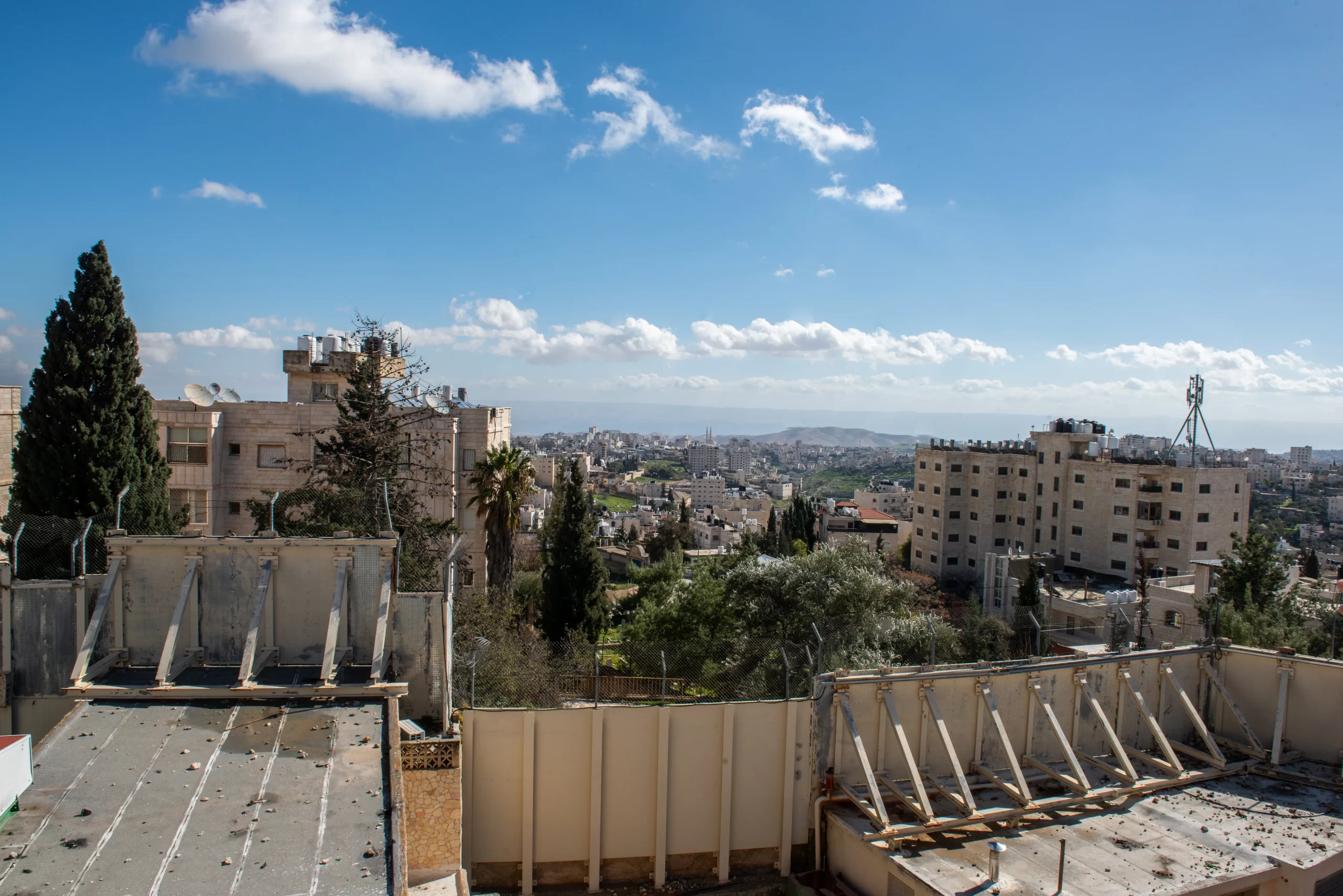 A view of the separation wall between Israel and the Palestinian Territories from the terrace of the Comboni Sisters' house in East Jerusalem. The wall, constructed by the Israelis in 2009, runs along the border of their property, dividing the village of Bethany/al-Eizariya in two, believed to be the site of the miracle of the raising of Lazarus. The sisters’ residence remains on the Israeli side, while the church and the tomb of Lazarus are on the other side of the wall. Credit: Marinella Bandini
