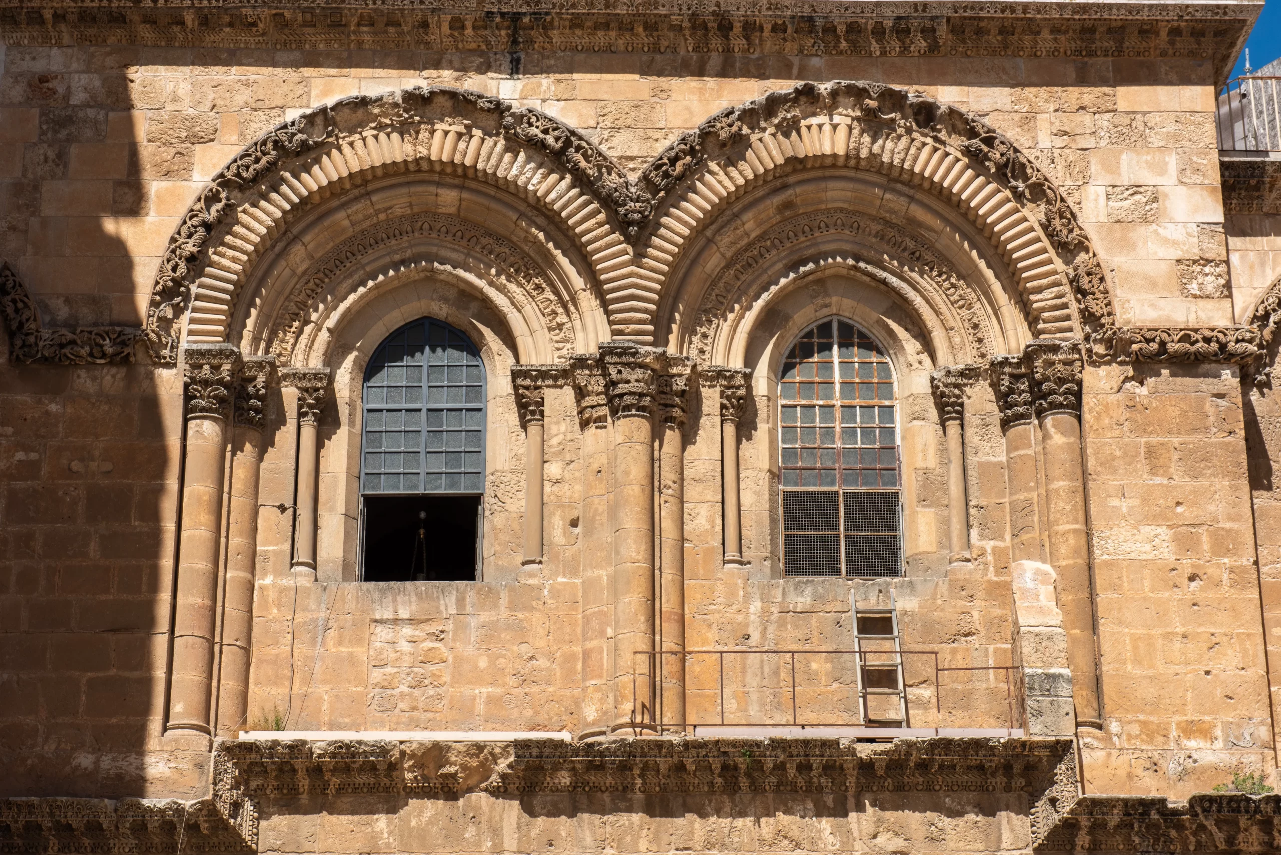 The iconic ladder outside the main facade in the Basilica of the Holy Sepulcher in Jerusalem. It remains a symbol of a distant time and the Status Quo. “The ladder belongs to the Armenians and shows that this area of the façade is their possession, even if the reason why is sort of lost in history,” Father Athanasius Macora said. It would be possible to move it with the agreement of the three Christian communities who "run" the basilica — Catholics, Greek-Orthodox, and Armenians. Credit: Marinella Bandini