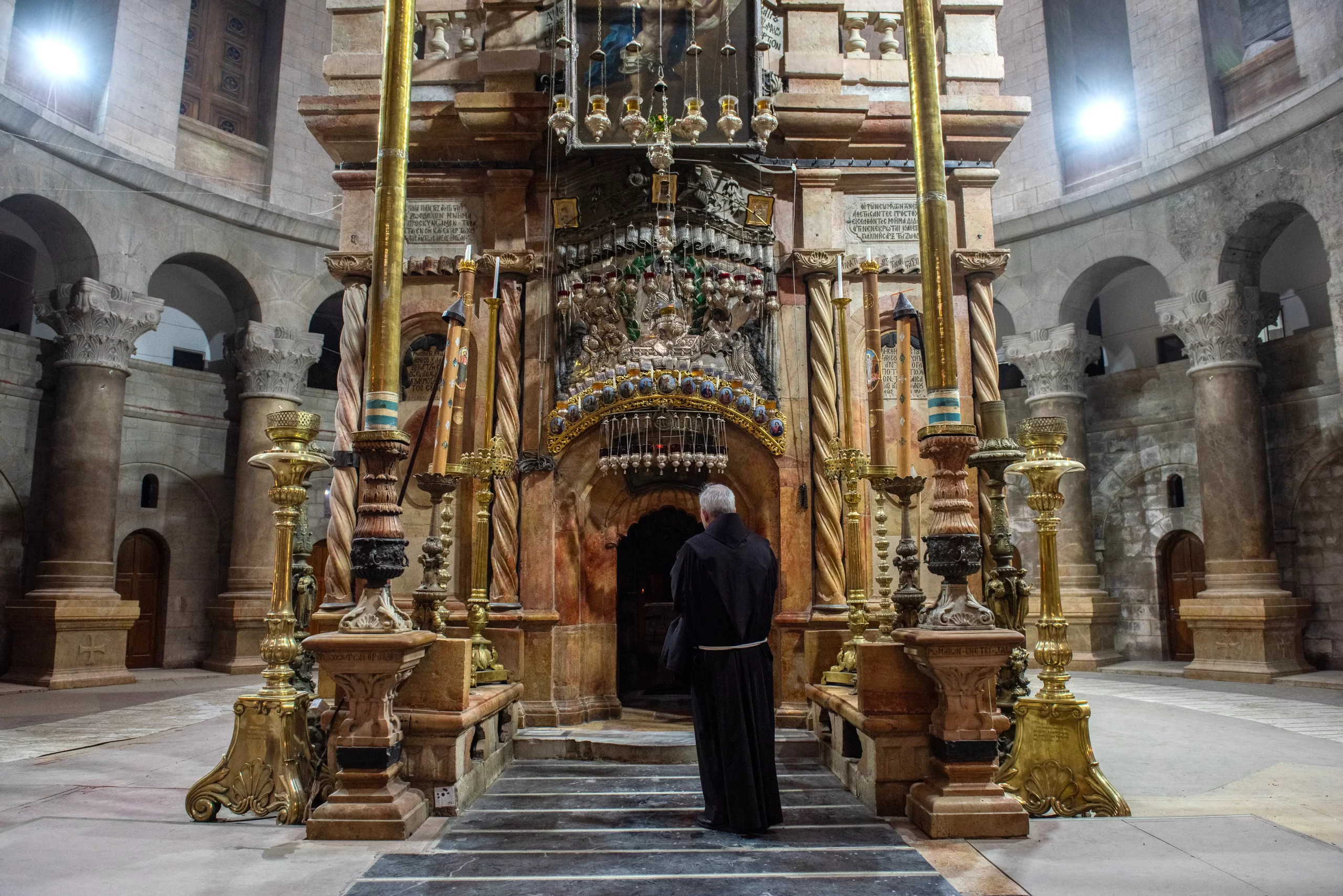 Father Athanasius Macora in front of the edicule of Holy Sepulchre, the shrine containing the tomb of Jesus Christ. Macora is an American Franciscan friar who has been the secretary for the Status Quo Commission of the Custody of the Holy Land for over 25 years. Credit: Marinella Bandini