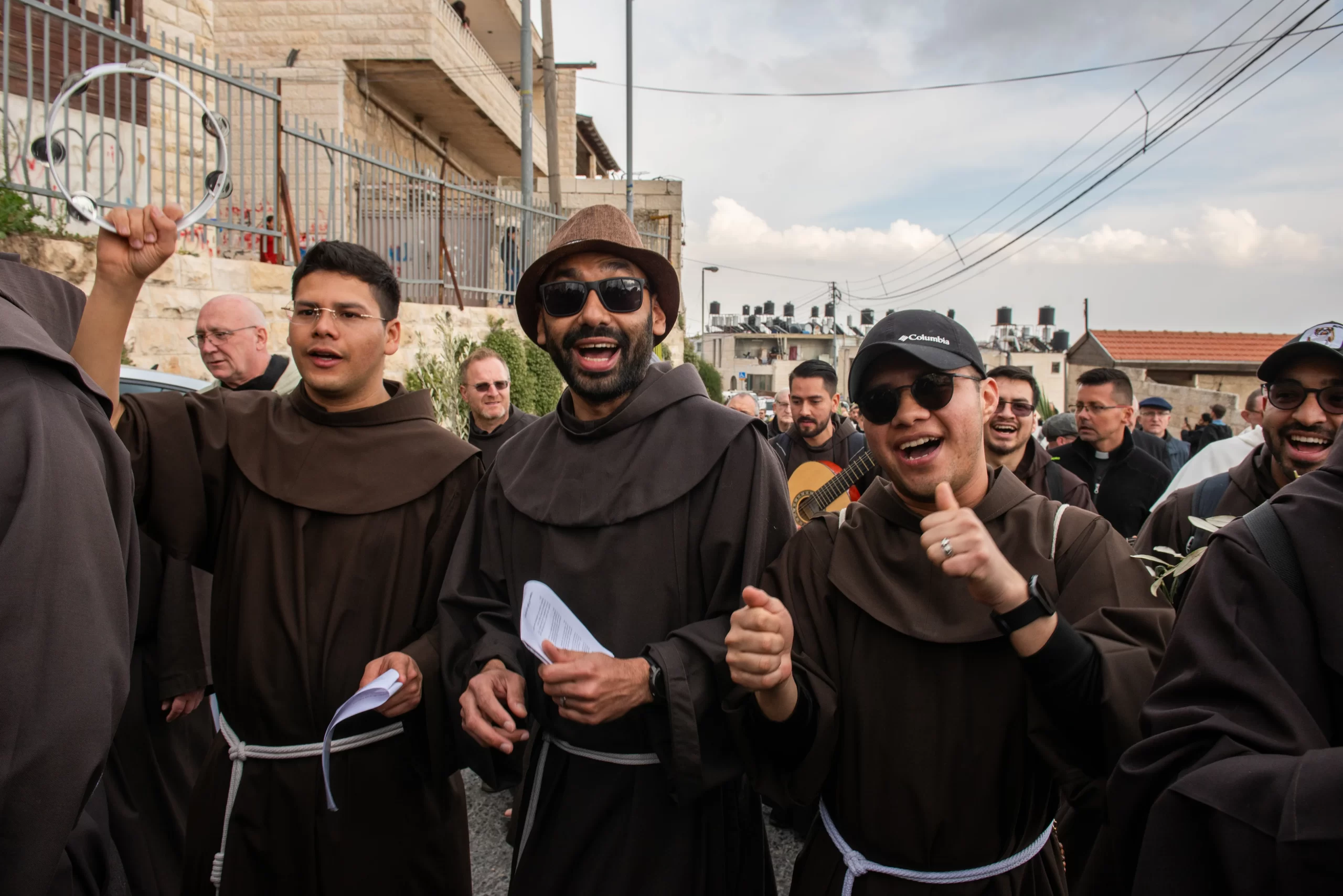 Franciscan friars from the Custody of the Holy Land play music and sing during the Palm Sunday procession from Bethphage to Jerusalem on March 24, 2024. The various communities present enlivened the procession with music, songs, and dances along the route, expressing praise to God and the joy of being Christians. Credit: Marinella Bandini