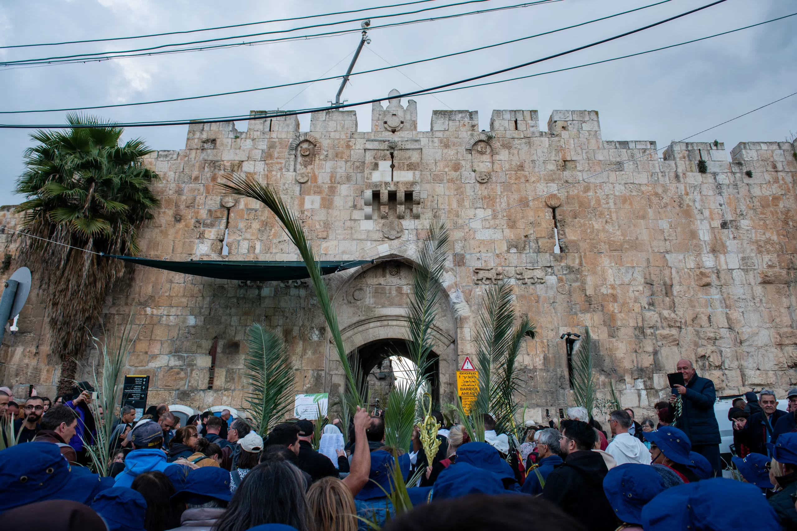 The Palm Sunday procession from Bethphage to Jerusalem, on March 24, 2024, enters Jerusalem through the Lion's Gate. Credit: Marinella Bandini