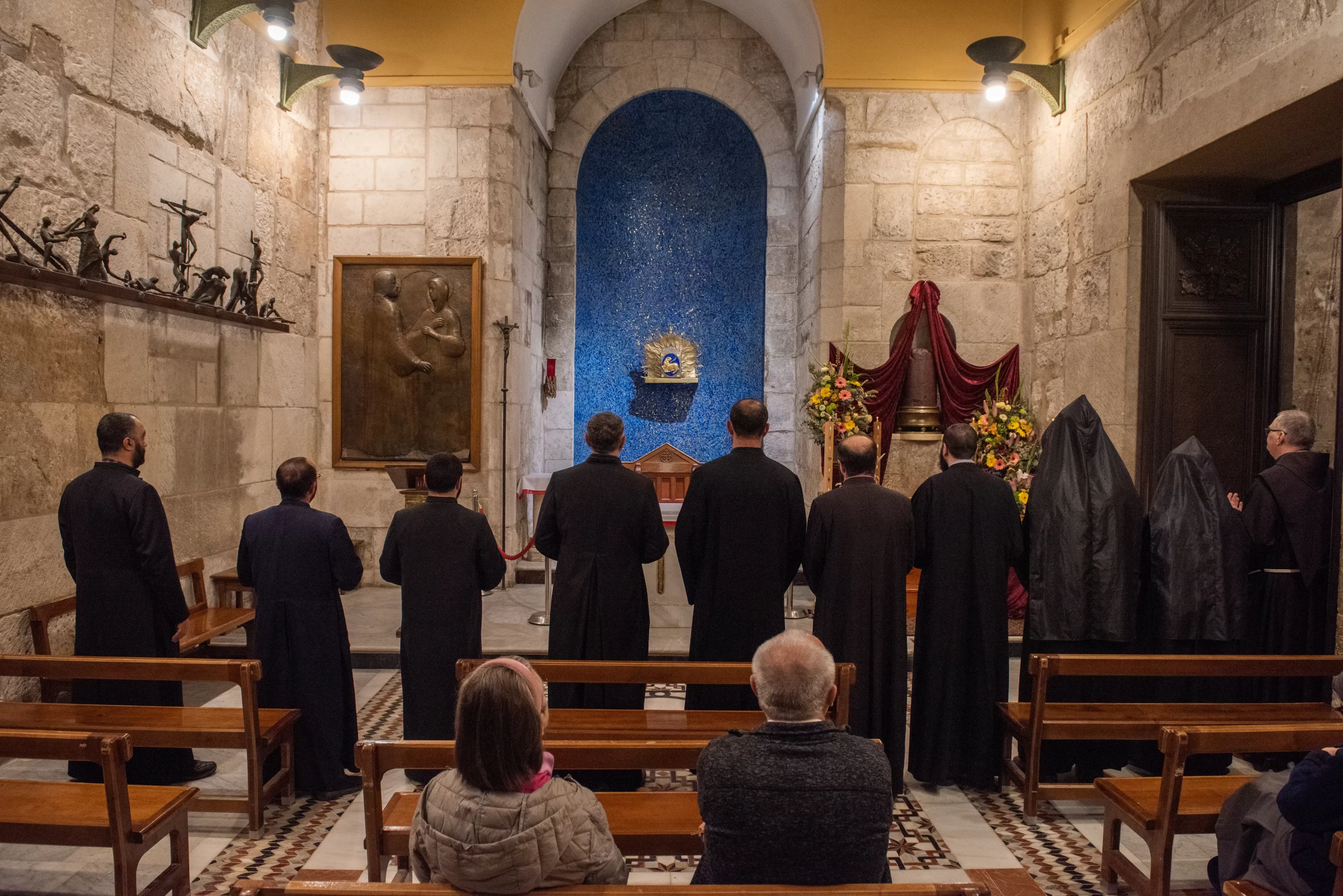 In the afternoon of Holy Wednesday, the Armenian monks of the community of the Holy Sepulcher visit the Chapel of the Apparition of the Franciscans and venerate the column of the Flagellation preserved there. After taking turns kissing the column, they all pray together in front of it. March 27, 2024. Credit: Marinella Bandini