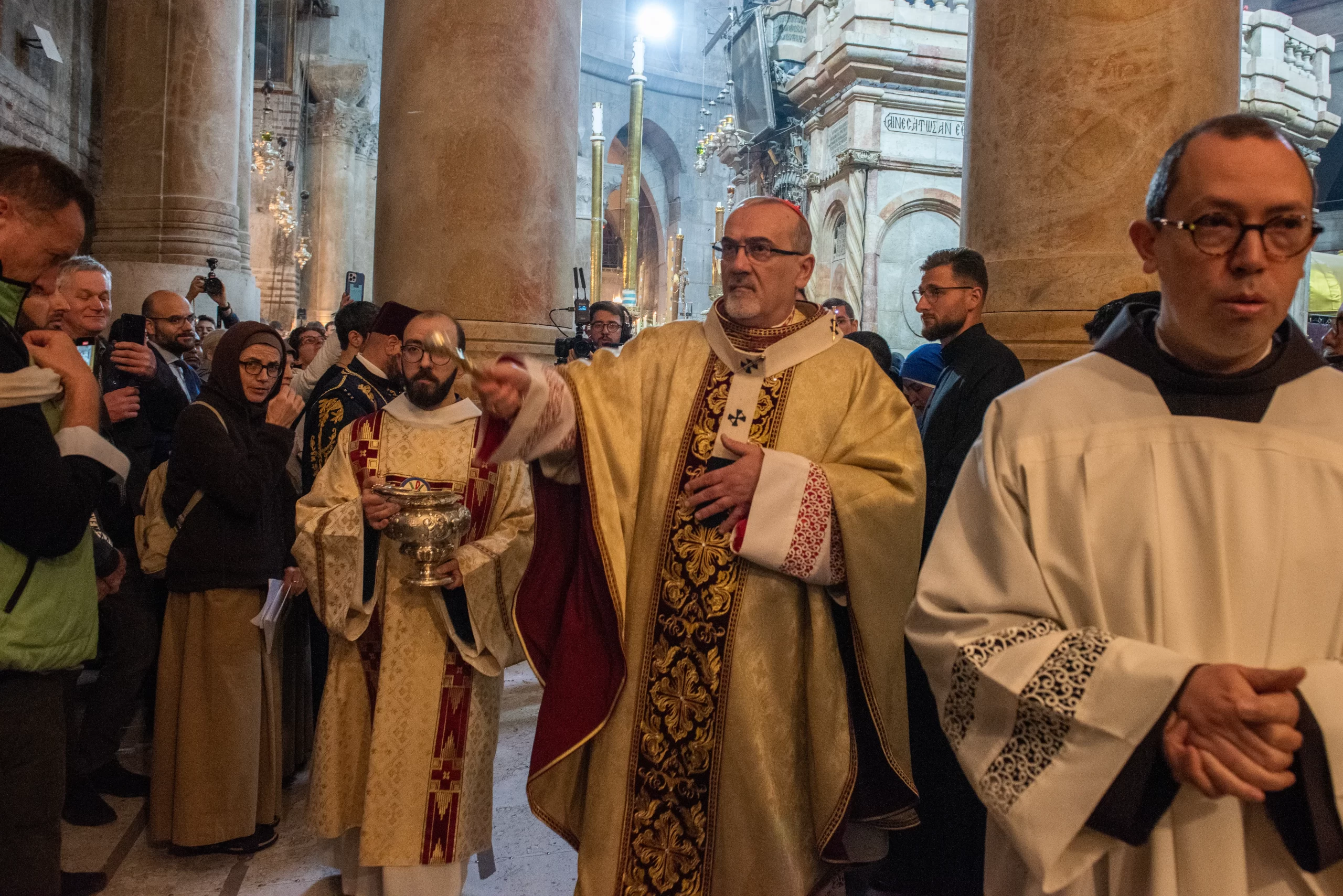 After blessing the water, Cardinal Pierbattista Pizzaballa, the Latin patriarch of Jerusalem, blesses the faithful during the Easter Vigil, celebrated on the morning of Saturday, March 30, 2024, in the Basilica of the Holy Sepulcher in Jerusalem. Credit: Marinella Bandini