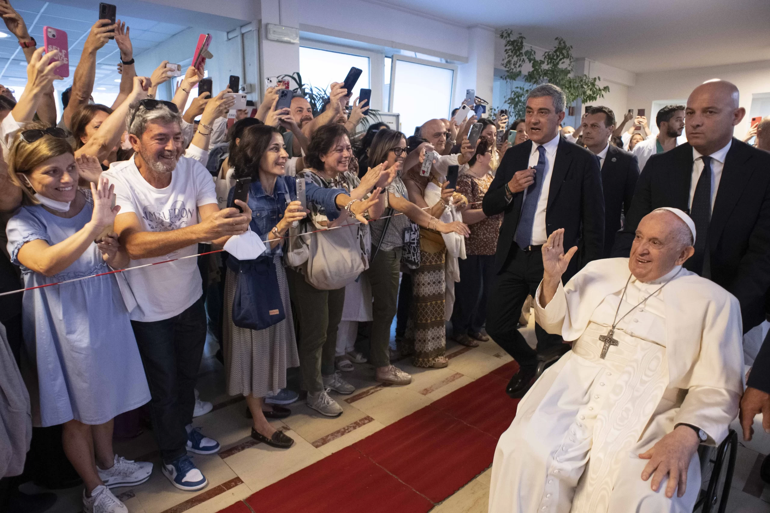 Pope Francis waves to other patients as he leaves Rome's Gemelli Hospital shortly before 9:00 a.m. on June 16, 2023. Before returning to the Vatican, he stopped to pray in front of the historic Marian icon of Salus Populi Romani at St. Mary Major Basilica, and made a quick visit to a group of religious sisters close to St. Peter's Square. Vatican Media.