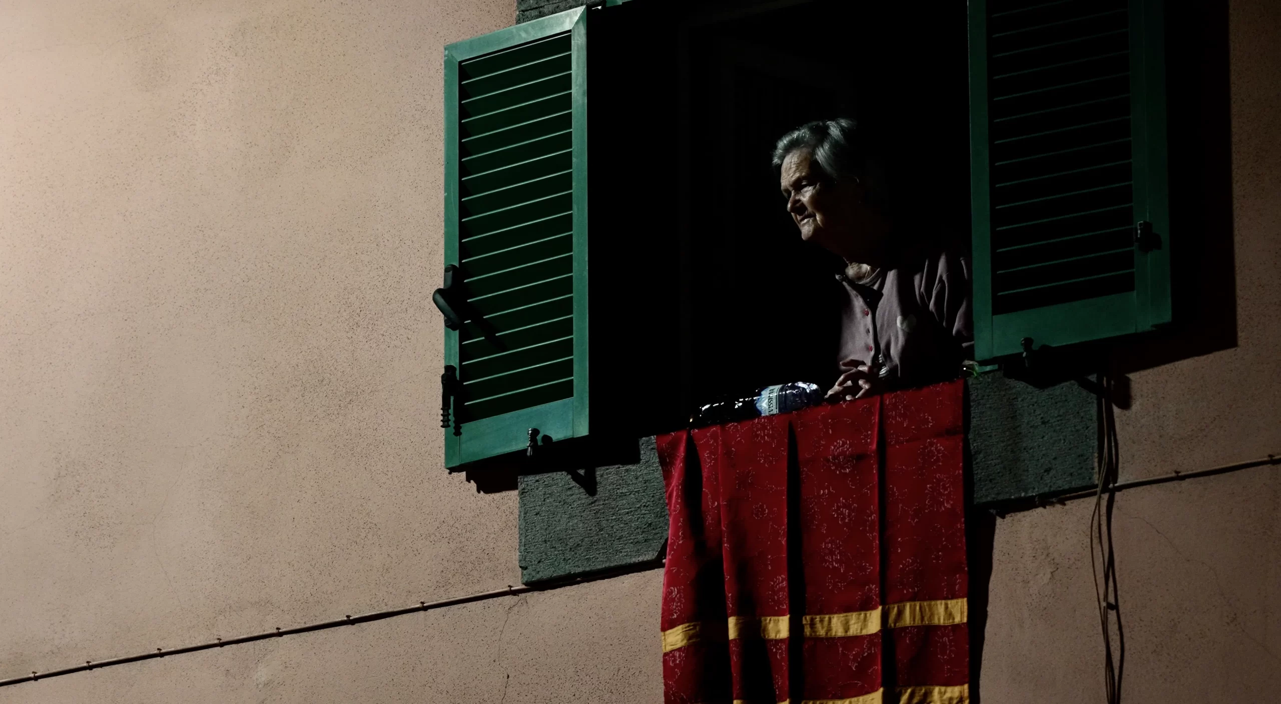 A resident of Bagnoregio, Italy, watches a candlelight procession through the streets of the town in honor of its patron saint, St. Bonaventure, on July 14, 2023. Patrick Leonard/CNA