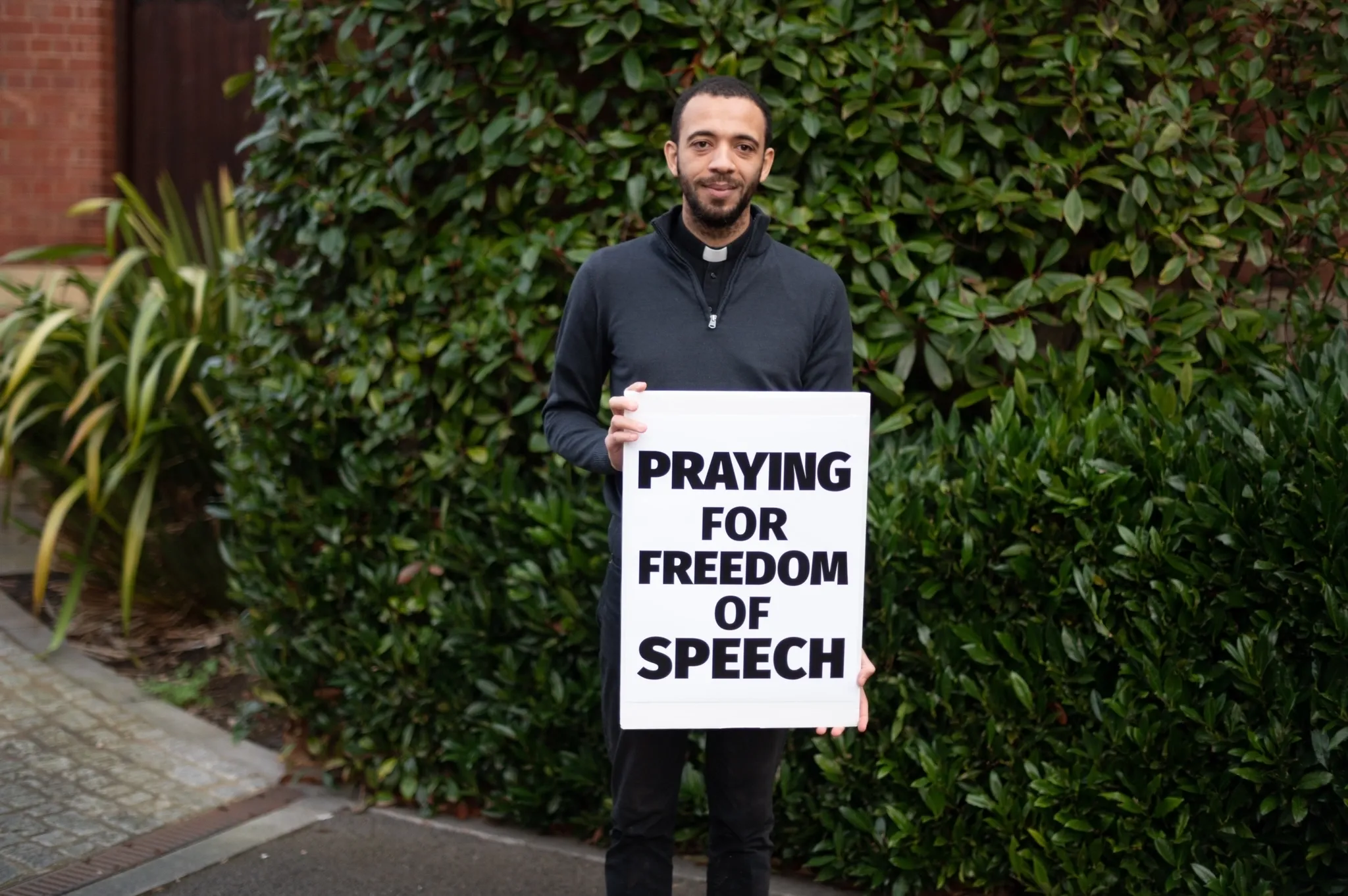 Father Sean Gough, a priest of the Archdiocese of Birmingham, England, stood near a closed abortion clinic on Station Road in Birmingham with a sign that said “praying for free speech.”. Credit: ADF UK