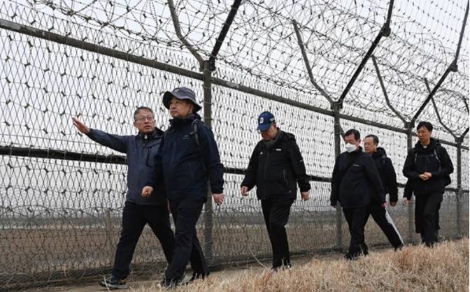 South Korean bishops walking alongside the barbed wire fence that has divided the two countries since the Korean War in 1953. Credit: Courtesy of South Korean Bishops' Conference