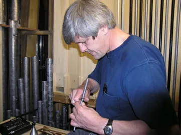 Martin Pasi, a long-time organ builder who is spearheading the establishment of Abbey Organ Builders, is voicing (tuning) an organ. Photo courtesy of Saint John’s Abbey/Father Lew Grobe and Kevin Vogt of St. Michael the Archangel Parish in Leawood, Kansas.