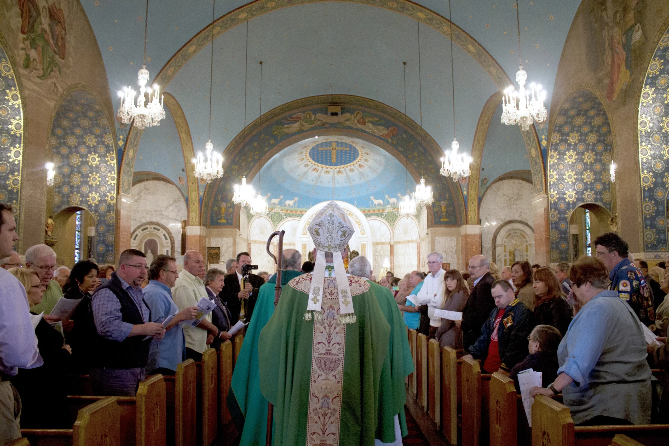 Auxiliary Bishop Donald F. Hanchon processes into Transfiguration Church in Detroit, part of St. John Paul II Parish, during Mass Mob XVII on Oct. 11, 2015. Photo courtesy of Detroit Catholic/Annie Schunior