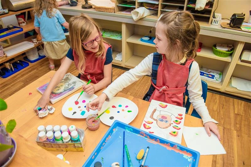 Children's House students at Christ the King Catholic Montessori School in Mandan, North Dakota, work on creating self portraits with paint in spring 2023. Credit: Mike McCleary/University of Mary