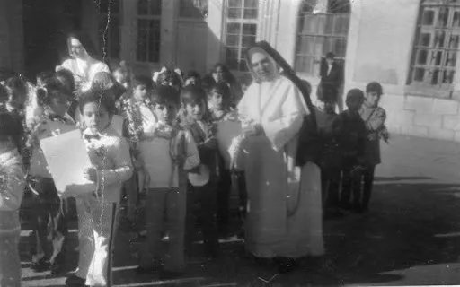 A photo of a Chaldean Catholic nun with school children circa 1973. Credit: Photo courtesy of Georgena Habbaba