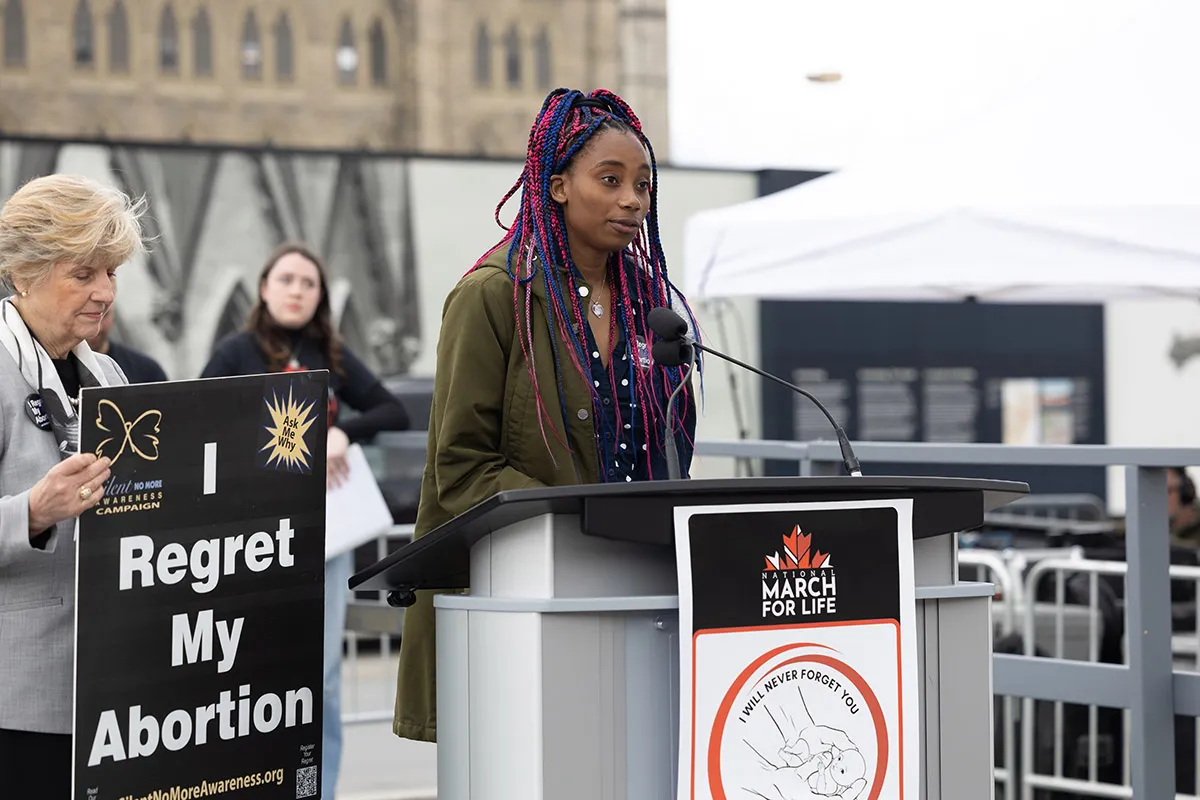 Nathalia Comrie shares the story of her abortion and the support she received from Silent No More Awareness Campaign and the Sisters of Life at the Ottawa, Canada, March for Life on May 9, 2024. Credit: Peter Stockland