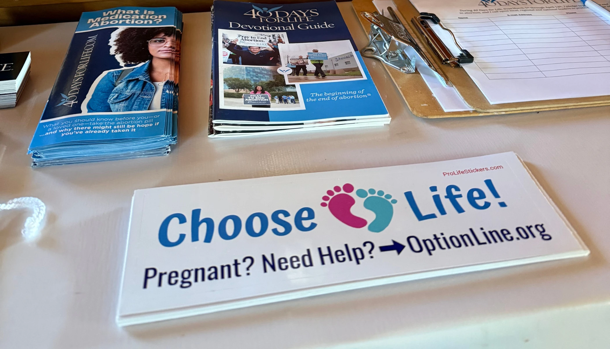 Gabriel Dionisi’s pro-life bumper sticker rests on an information table with other resources for pregnant women. Credit: Photo courtesy of Kevin Jorrey