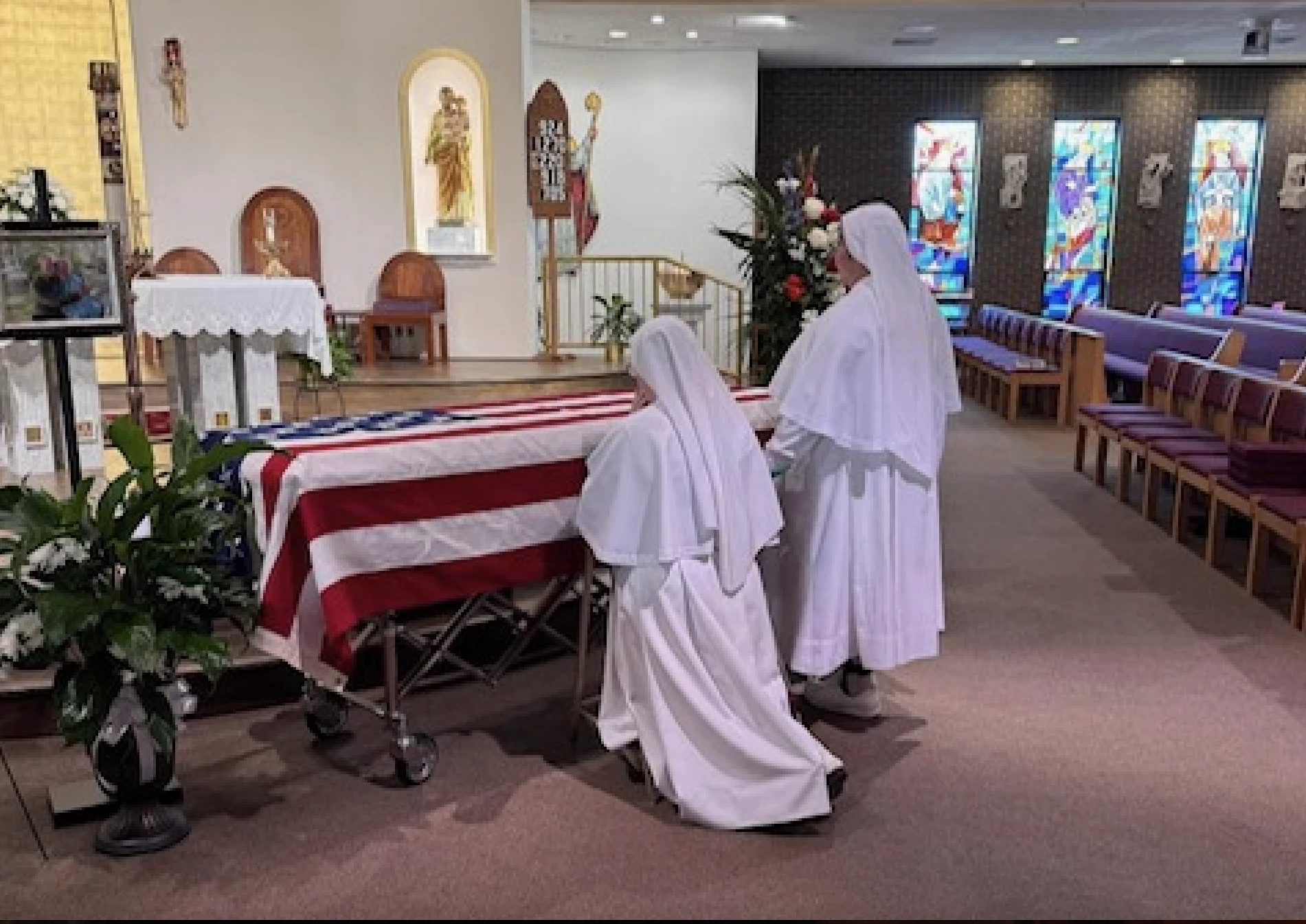 Sister Catherine (left) and Sister Dorian Salvador (right) pray for the soul of Kim DeSopa’s father on Oct. 1, 2024, at St. Clement of Rome Church in Metairie, Louisiana. Credit: Photo courtesy of Kim DeSopa and Sister Catherine