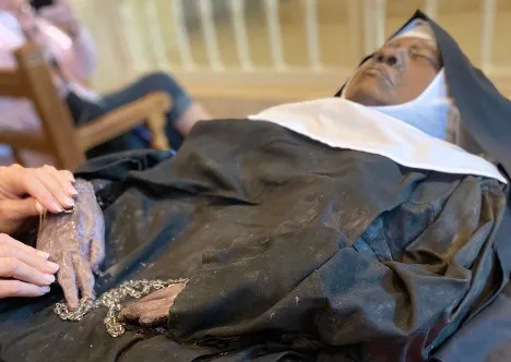 A pilgrim venerates the incorrupt body of Sister Wilhelmina Lancaster, OSB, on May 20, 2023. Lancaster was recently exhumed in Gower, Missouri. Credit: Kelsey Wicks/CNA