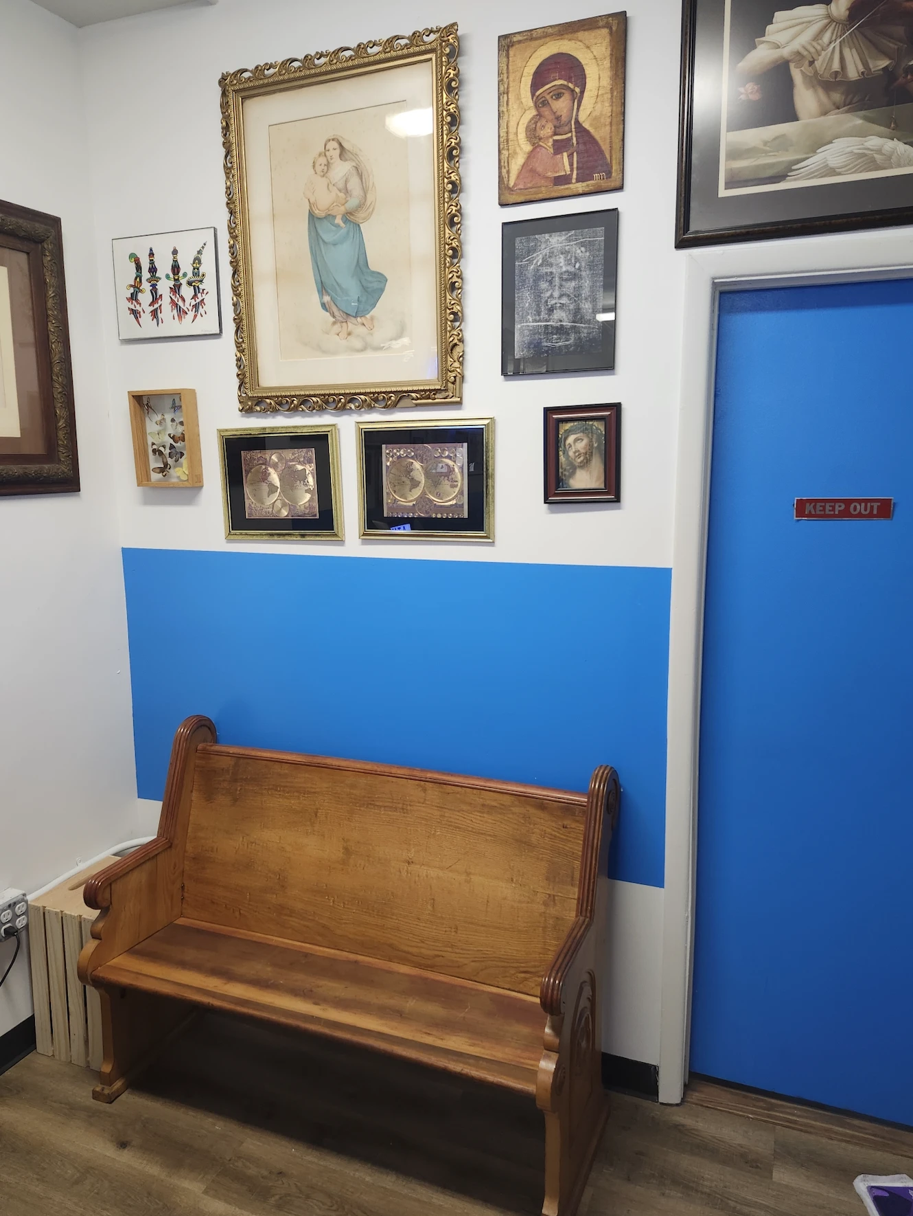 An old church pew serves as a waiting area for customers inside Times Square Tattoo. Credit: Photo courtesy of Tommy Houlihan