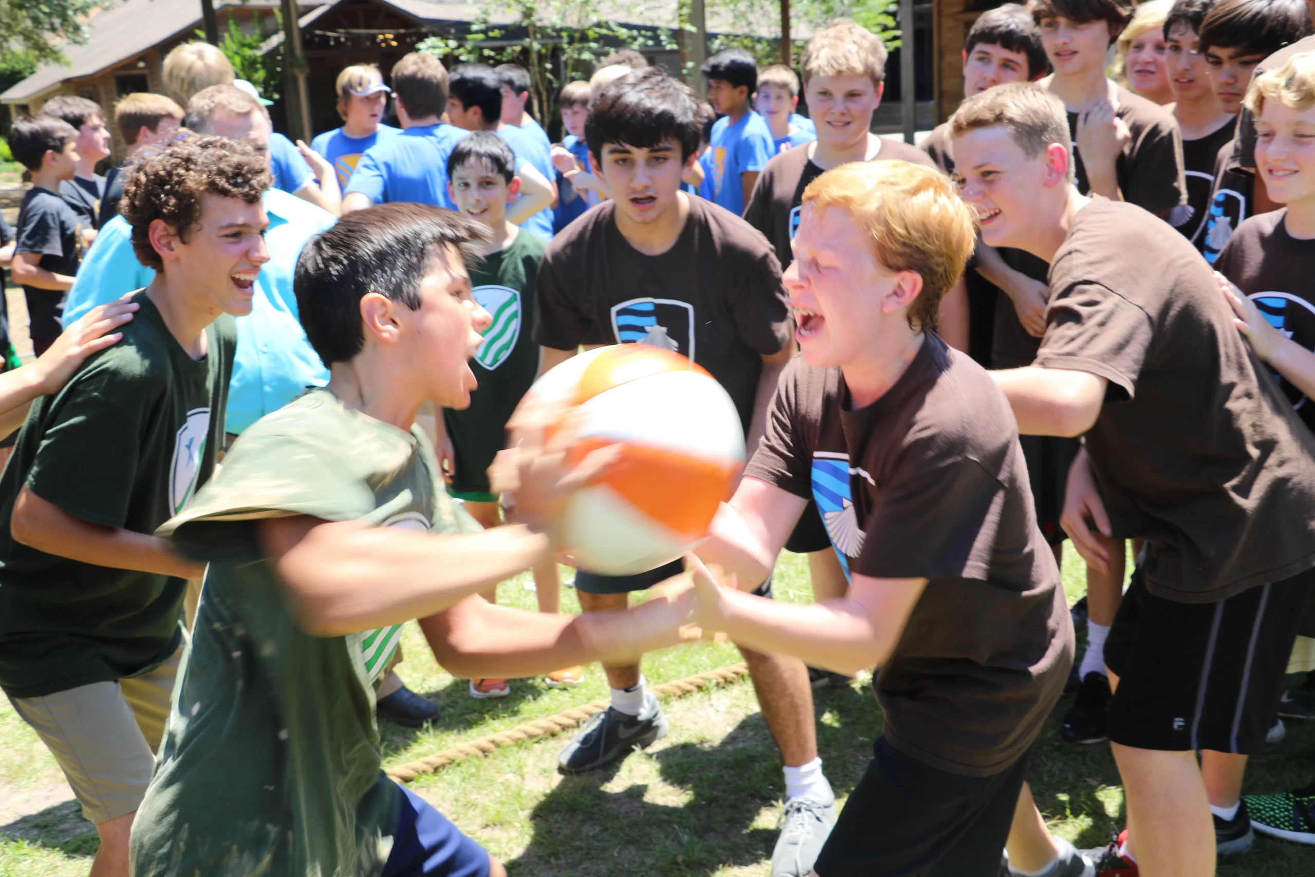 Boys cheer  their teammates on as the houses compete in a game of "Thud," in which two boys throw a medicine ball at one another as hard as they can until one of them drops it or gives up. Credit: Courtesy of Western Academy