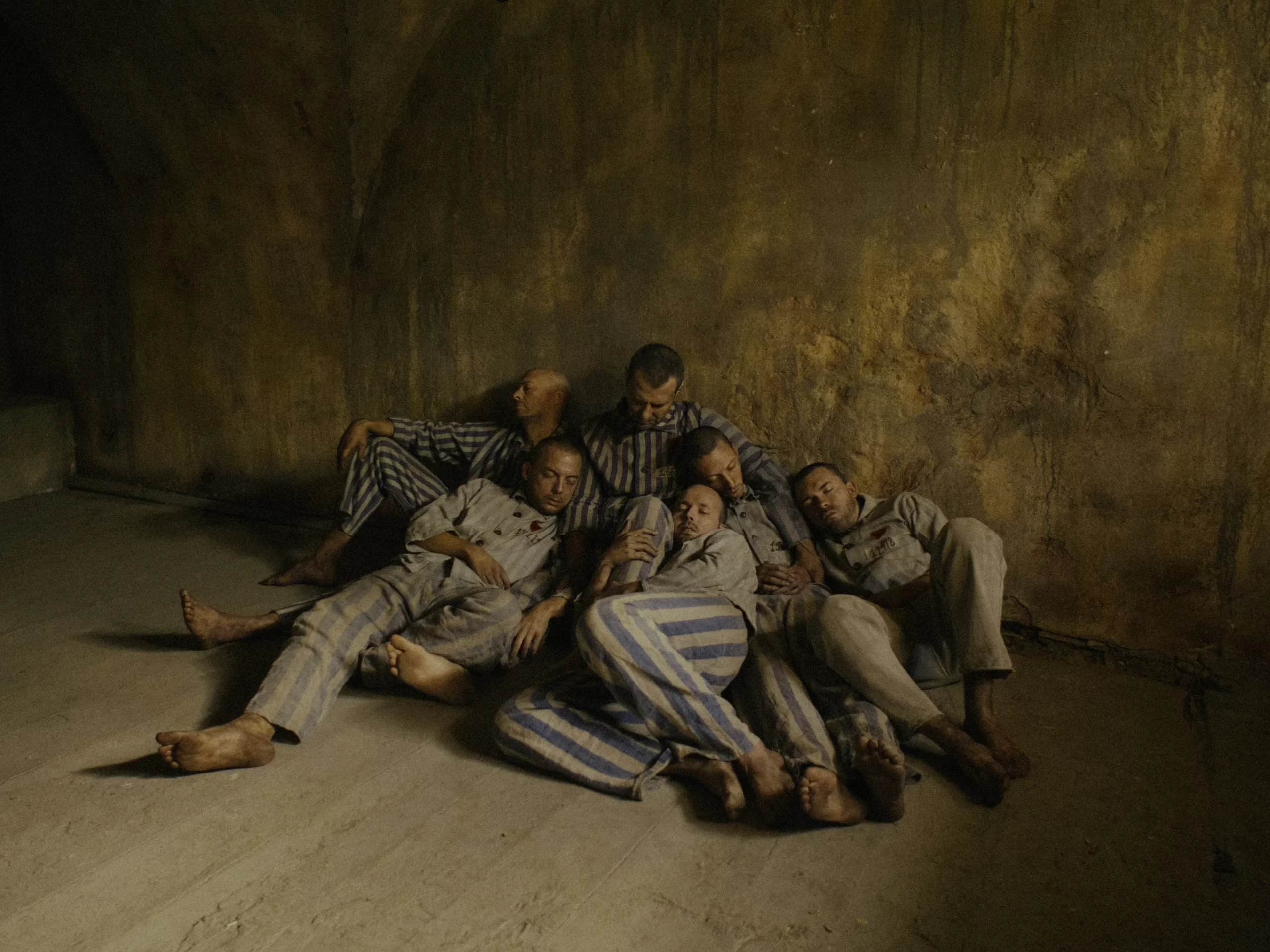 A portrayal seen in "Triumph of the Heart" of Maximilian Kolbe, along with the other men, in the starvation bunker. Credit: Triumph of the Heart movie/Sherwood Fellows