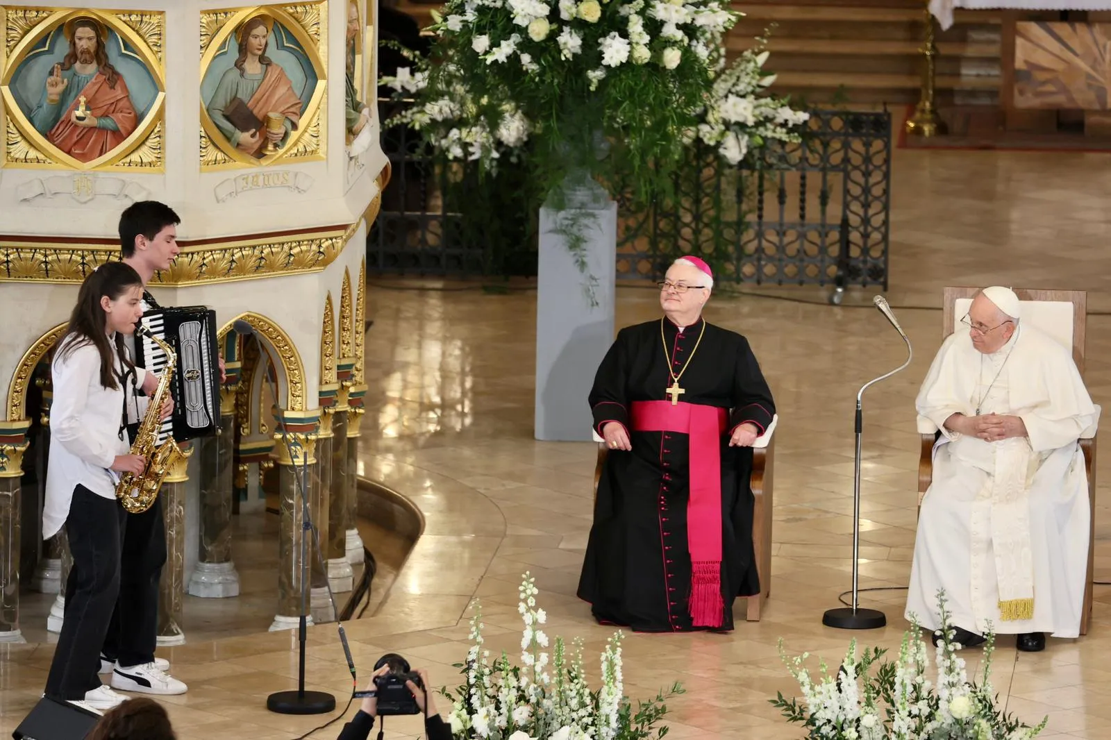 Pope Francis attends a meeting with poor people and refugees at St. Elizabeth of Hungary Church in Budapest, Hungary, on April 29, 2023. Francis was greeted at the meeting by people who shared testimonies of their struggles, including a Ukrainian family that has found refuge in Hungary. The oldest two children of the family, on accordion and saxophone, perform an Argentinean tango for the pope. Daniel Ibañez/CNA