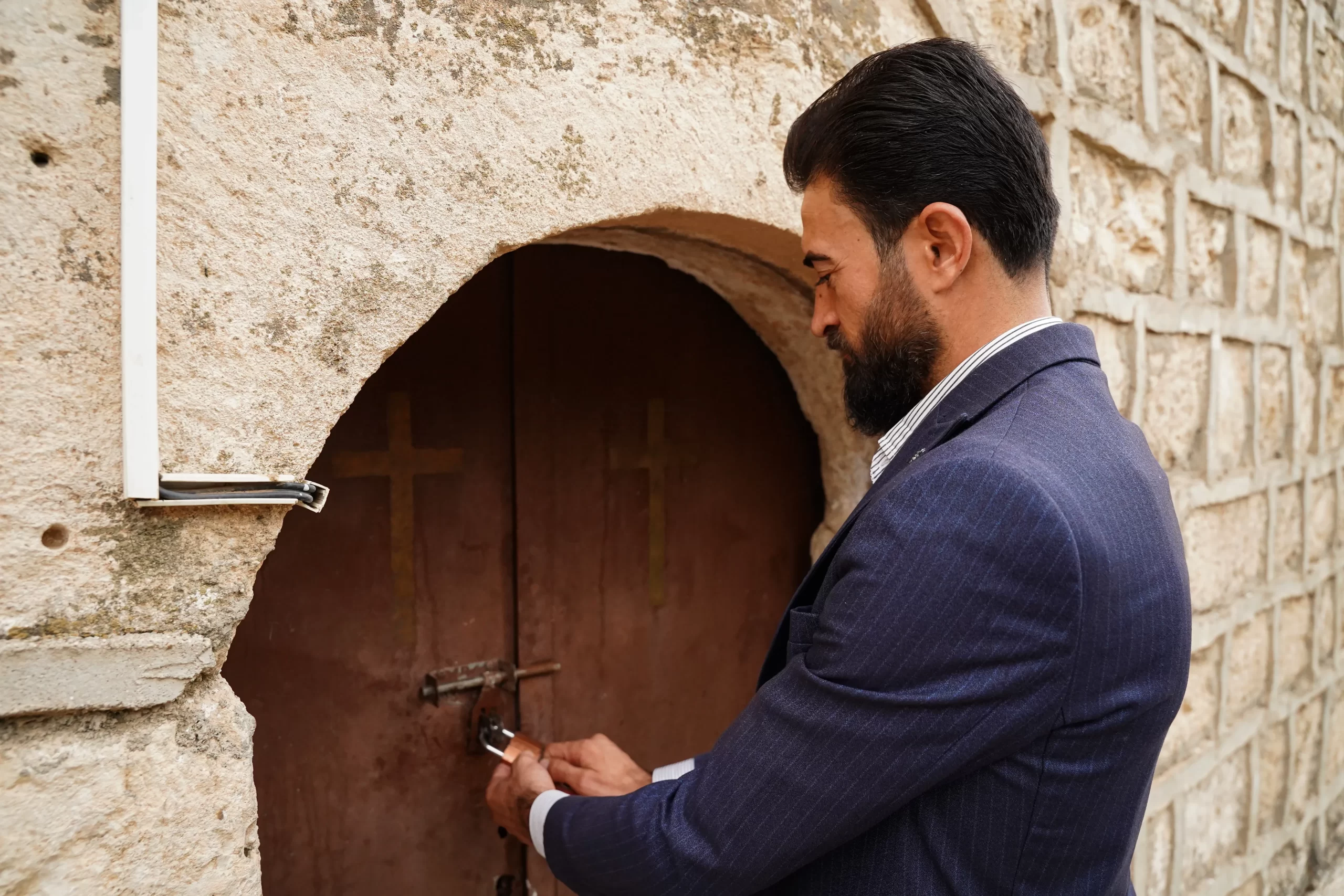 Wael Jejo Khdeida, a young Yazidi man, holds the keys to his village’s church and cares for it. Credit: Ismail Adnan/ACI MENA