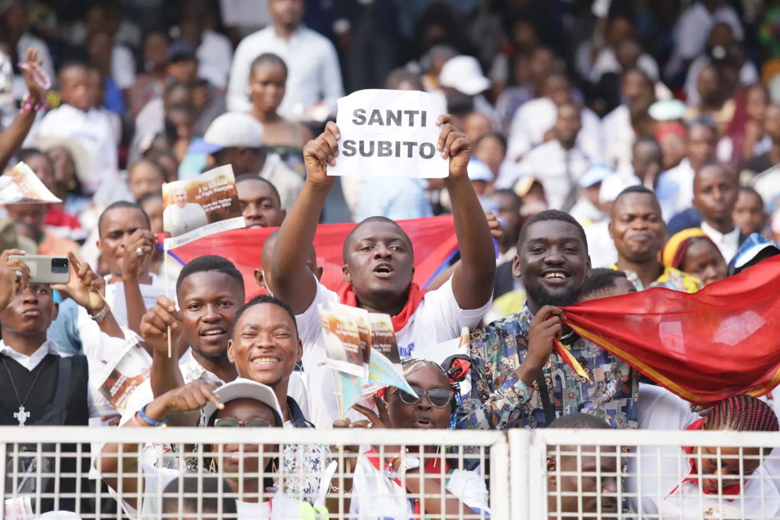 A spectator at Martyrs' Stadium in Kinshasa, DRC, on Feb. 2, 2023, holds a sign with the phrase "santi subito" in reference to two Congolese blesseds. Elias Turk/CNA
